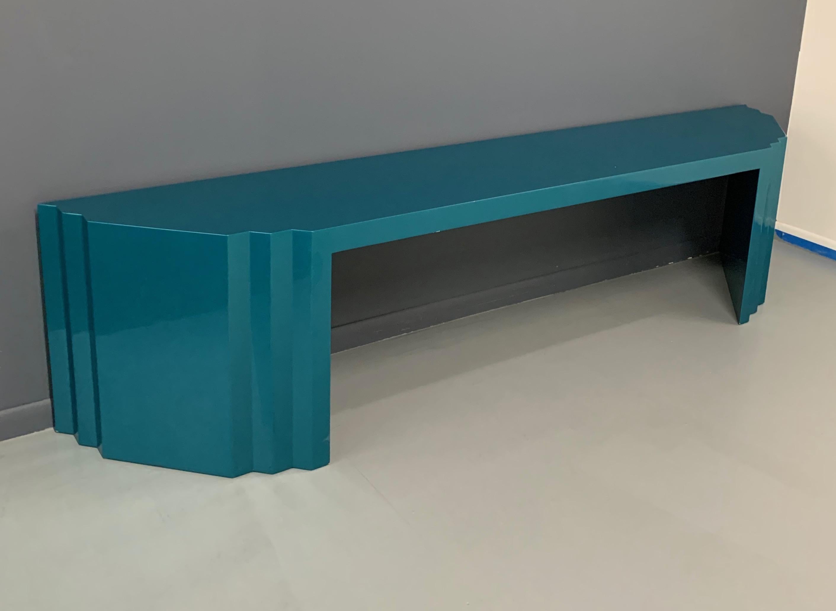 Impressive console table finished in a glossy teal lacquer. 107