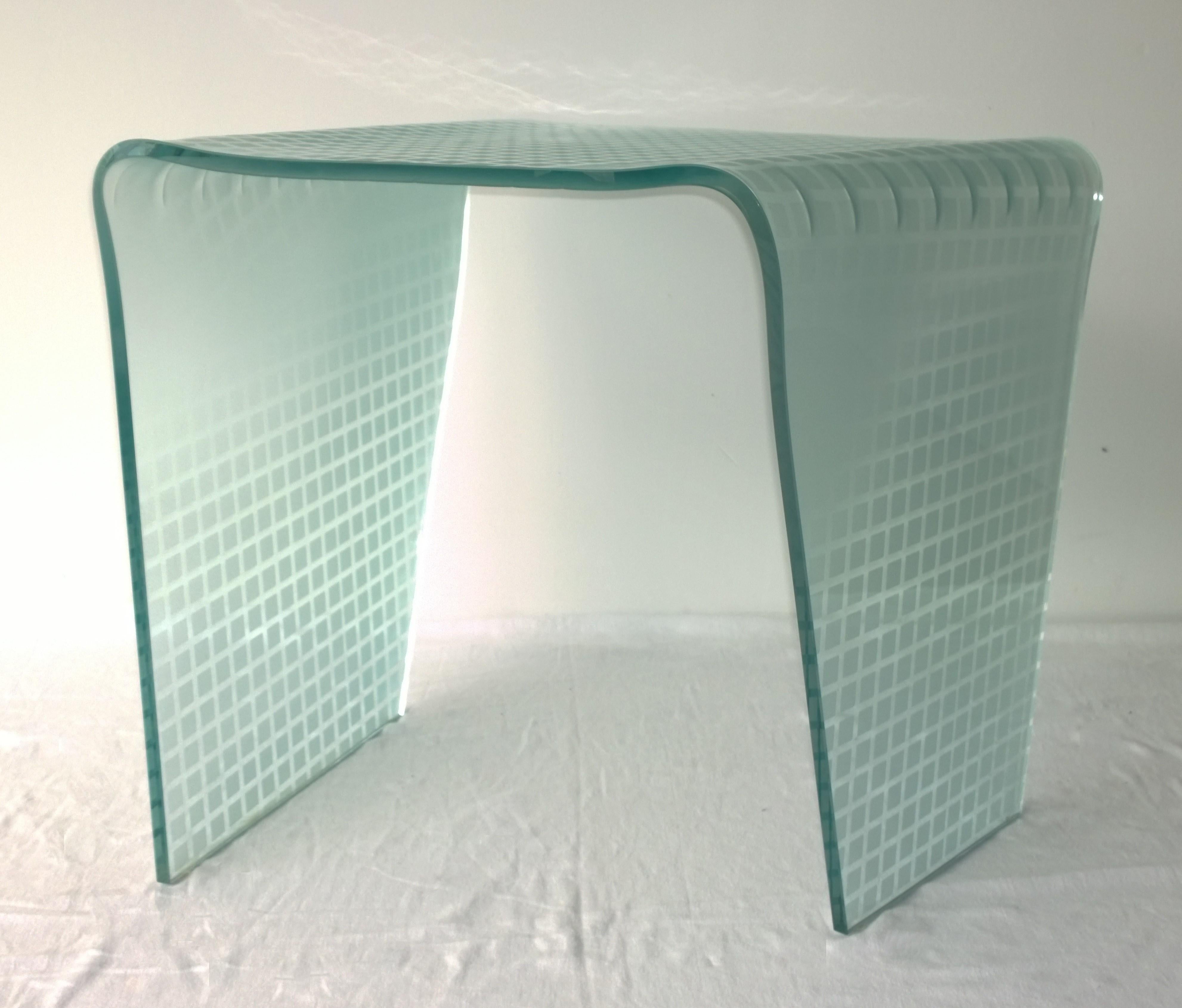 Offered is a organically shaped, Postmodern Italian side table or end table or occasional table with an etched white biased grid pattern over bent sea green glass by Angelo Cortesi for Fiam Italia. This etched bent glass table indicative of a design