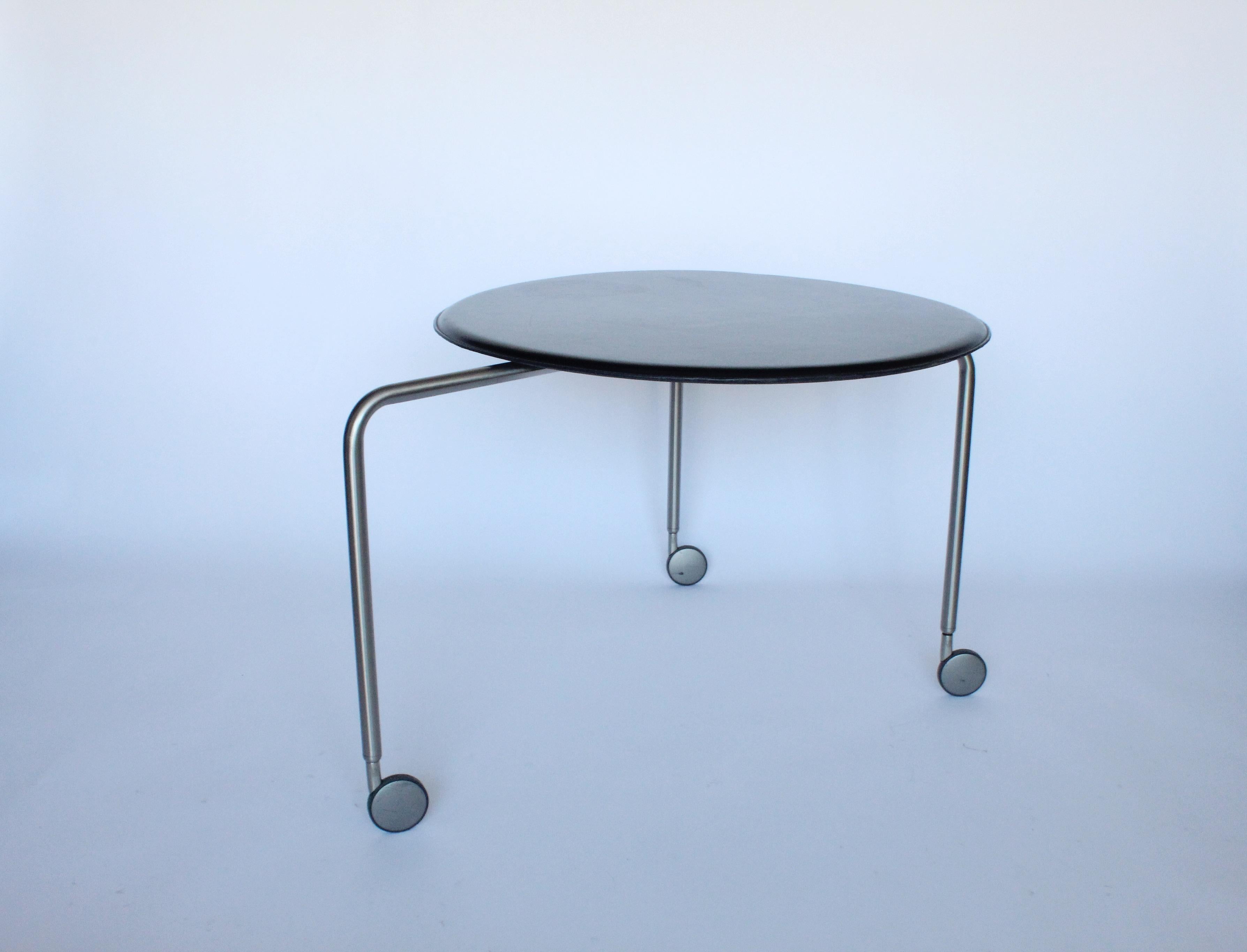 Wonderful example of Italian Postmodern design. Versatile piece on casters that can be used as tea cart, bar cart, serving cart, table. Table is made of leather and stainless steel with exceptional Italian craftsmanship. Table is in great vintage
