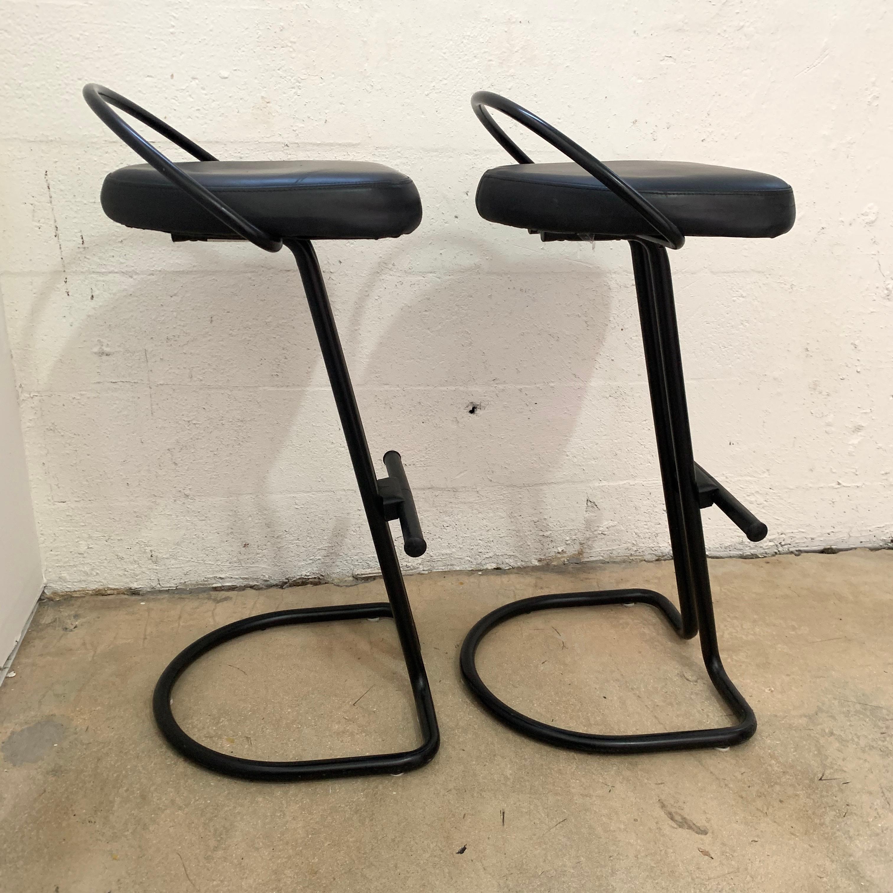 Postmodern cantilevered barstools rendered in black painted tubular metal frames with a black rubber seat, made in Italy, 1990s.