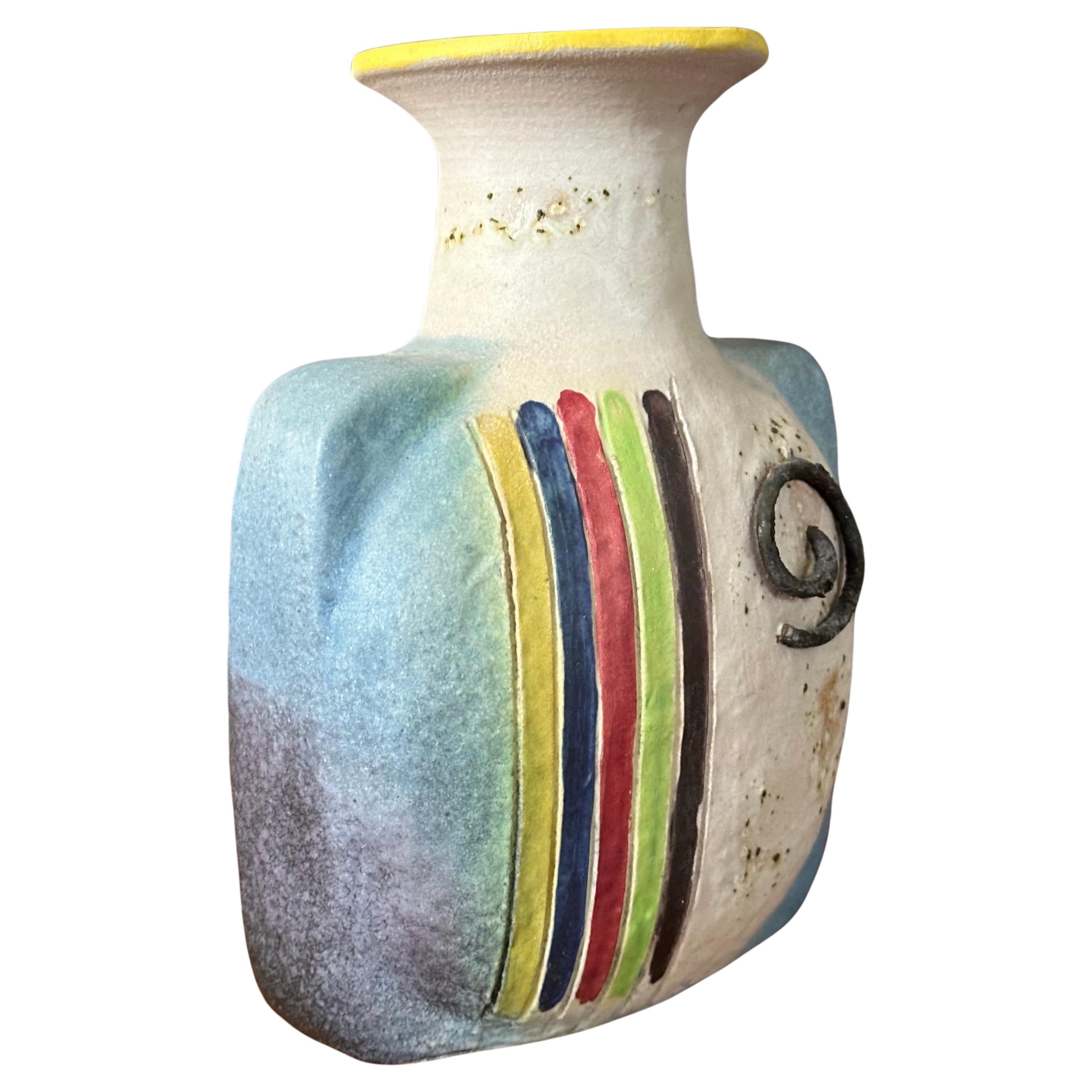 A vibrant MCM Italian ceramic vase by Ivo de Santis for Gli Etruschi, circa 1960s.  The vase features colorful stripes and a spiral accent. Signed on the underside.  The hand thrown vase is in great vintage condition with no chips or cracks and it