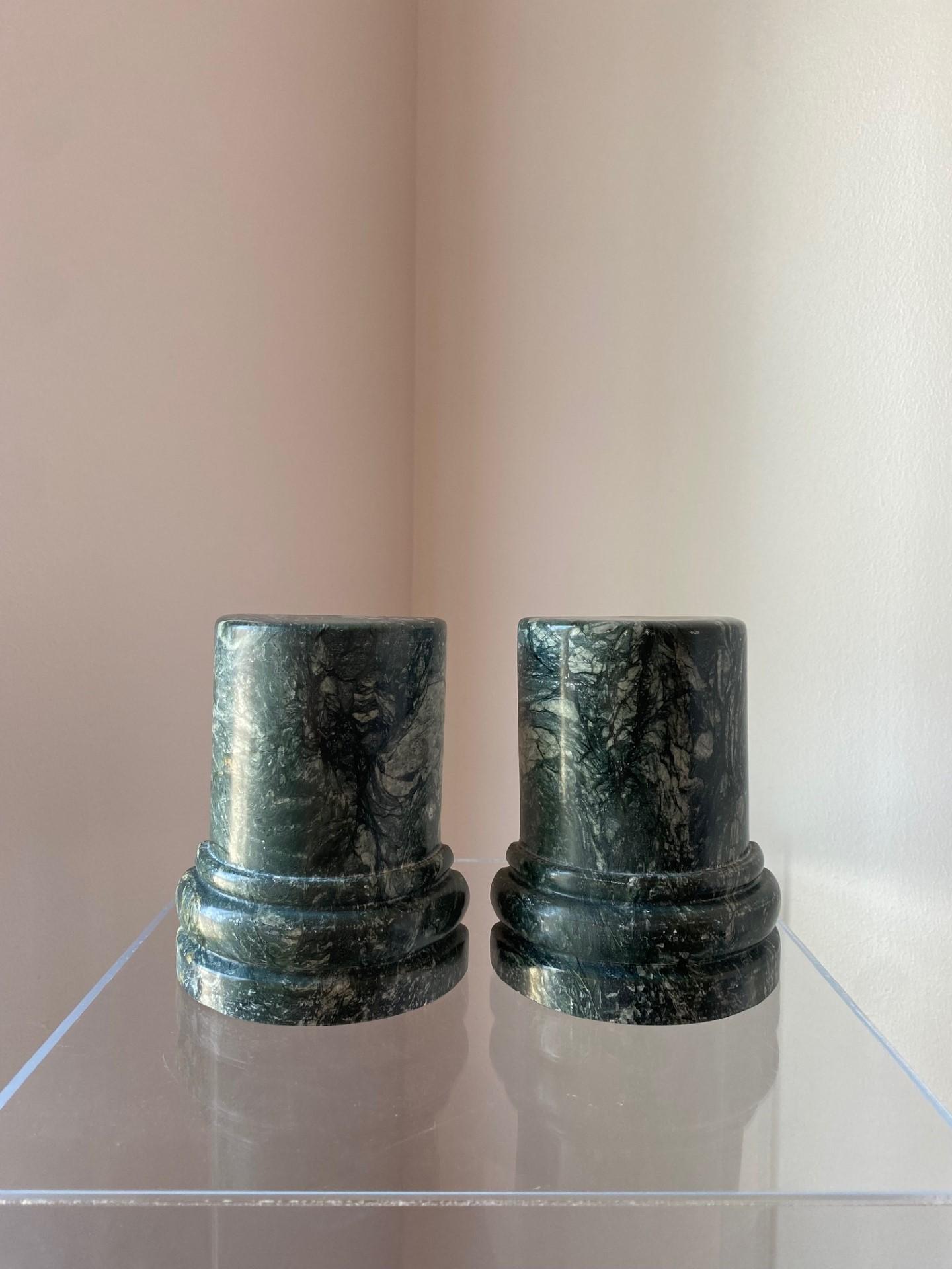 Beautiful pair of postmodern marble bookends from Italy. These sizeable pieces of marble are captivating as they are commanding. The veining that develops on the green marble with green undertones ondulates as the shape forms columns that melt