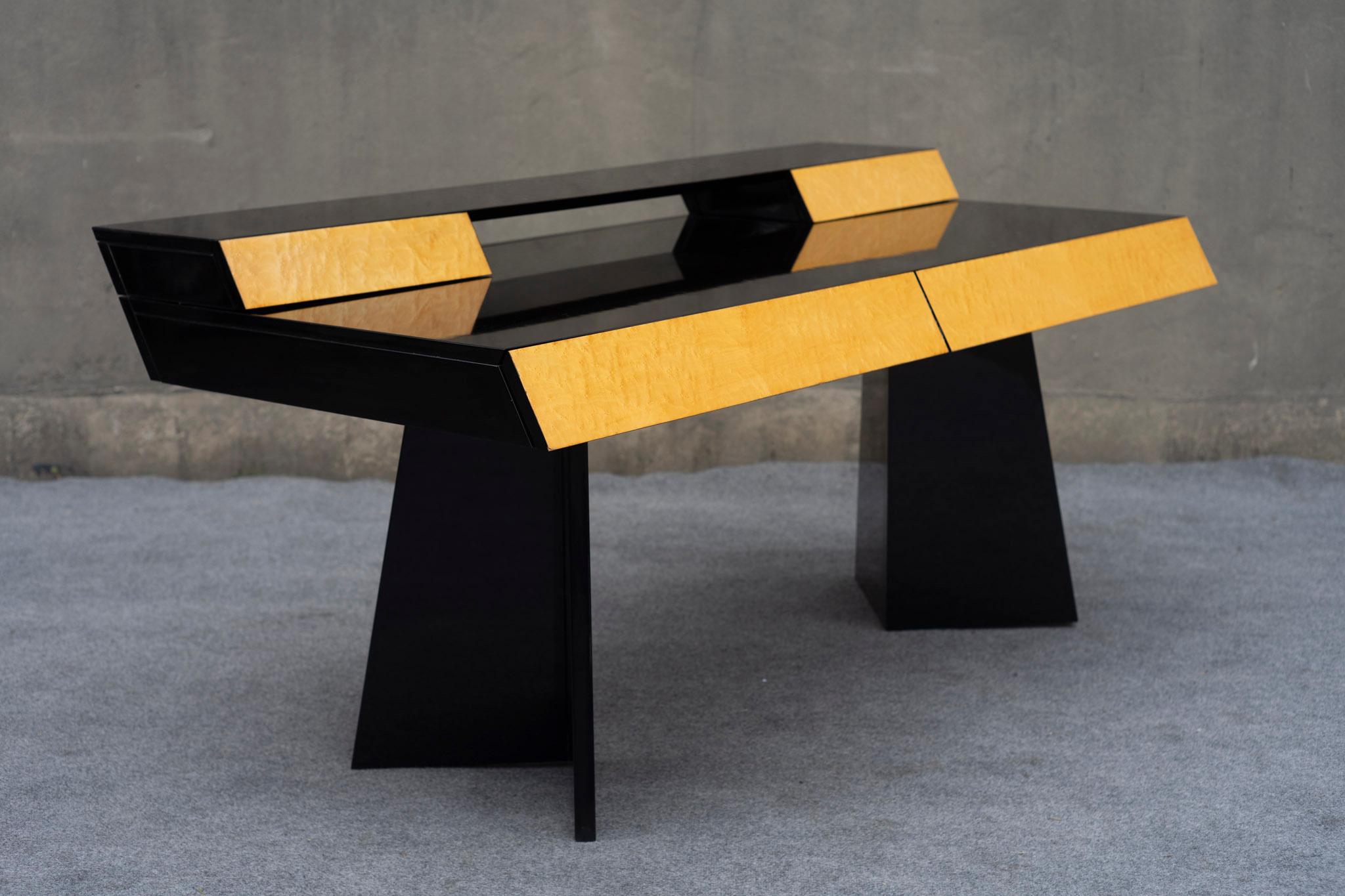 Made in the 1980s in Italy, this desk features a sleek, post-modern, and angular design. Finished in a gloss piano black complemented by burl drawer-fronts, the large work surface has space for anything you might need to be most productive. Plenty
