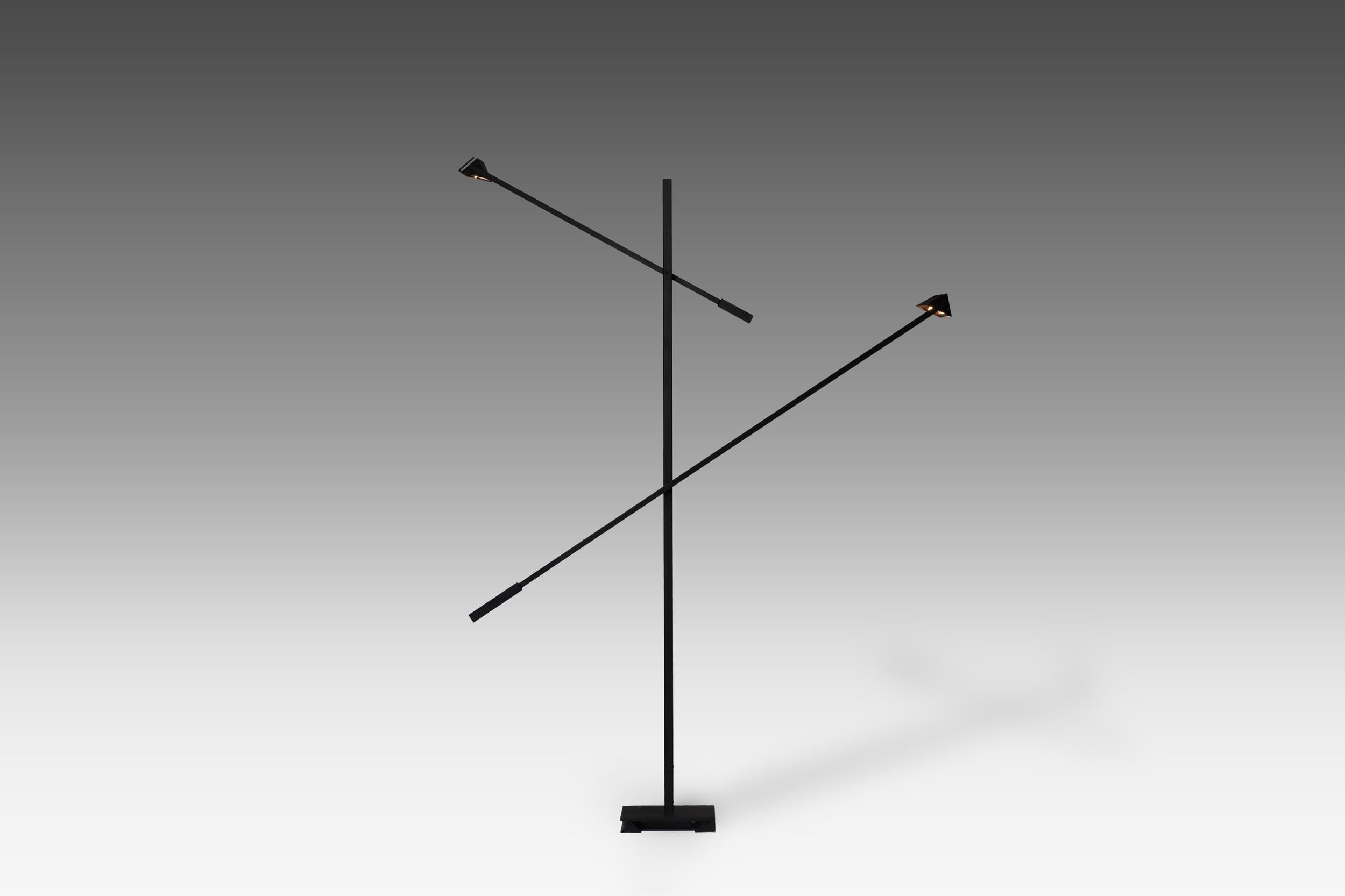Large and sculptural Postmodern floor lamp, Italy, 1970s. The lamp is constructed out a of black lacquered rectangular metal frame with two triangle shaped adjustable shades. A striking appearance due to its sharp graphic architectonic lines and