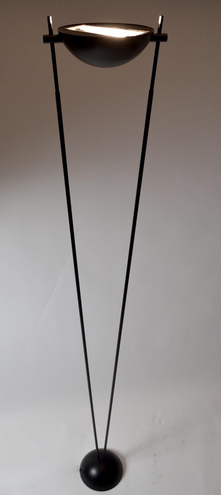 Graphic Minimalist black metal halogen uplight torchiere made in Milan (Milano) Italy. Period Post Modern 1980s Italian lighting design. The lamp has an in line on/off dimmer switch, which is marked with the RELUX brand, as pictured. Bowl shade
