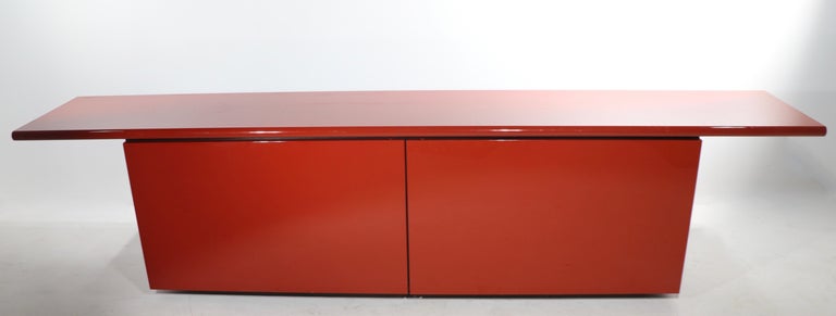 Iconic Post Modern Italian design sideboard designed by Lodovico Acerbis and Giotto Stoppino for Acerbis International, circa 1970/1980's. Ingenious forward looking design, features two doors which slide half way across the front, then swing open to