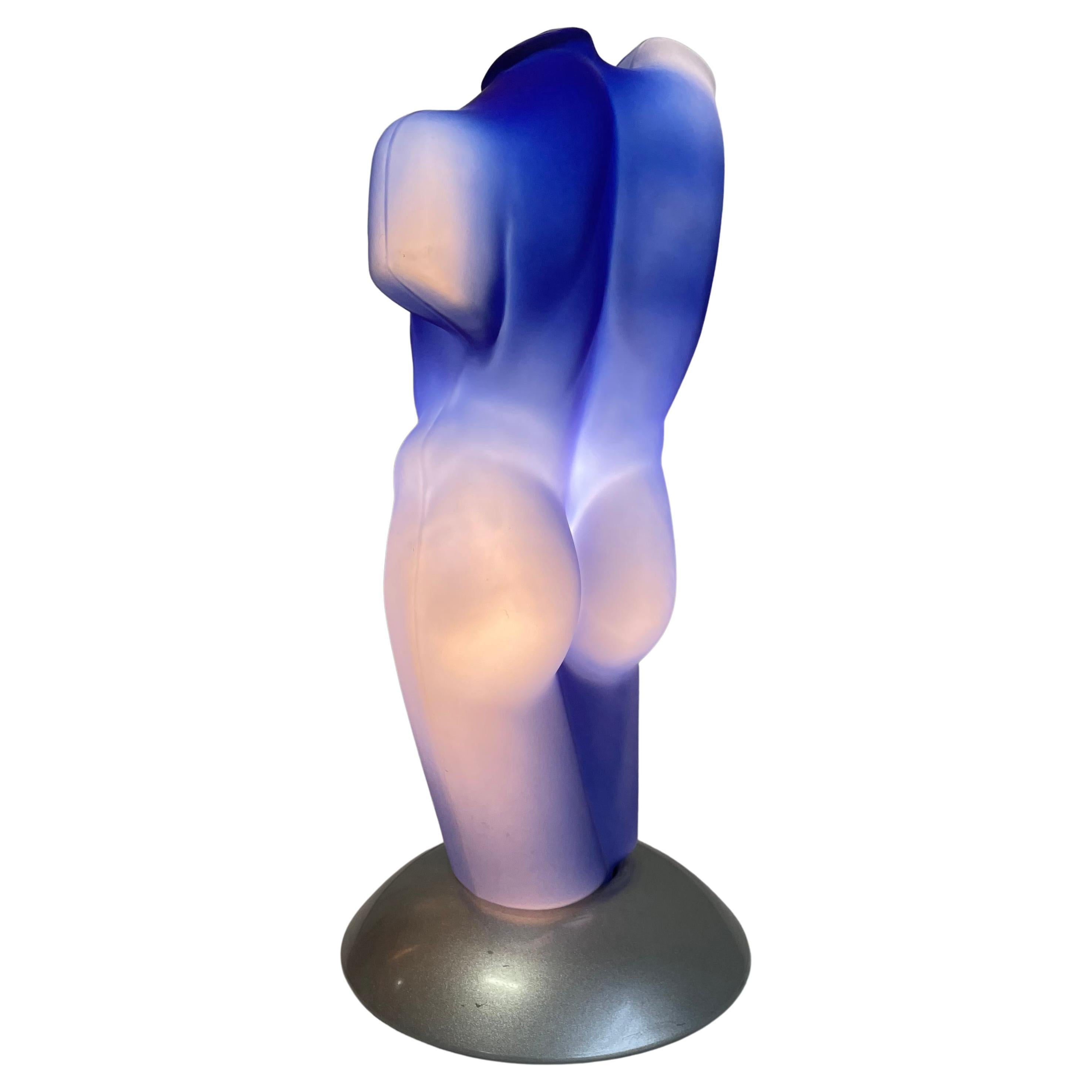 Italian postmodern table lamp features a stunning Yves Klein blue frosted glass sculptural lampshade in the form of a classical Greek god's male torso.
The base of the lamp is made of metal painted in grey-silver color with a metallic finish.

The