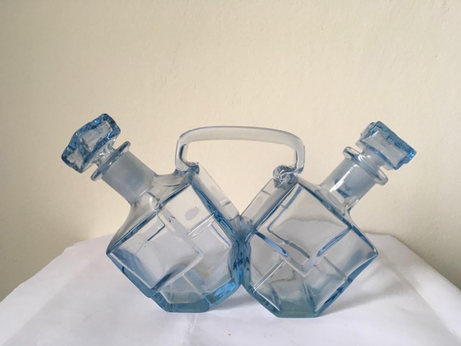 Italian Murano glass double oil and vinegar cruet set. The design of the bottles, brings the work closer to the Italian Post Modern design. Elegant and fine light blue tone.

The piece is in good conditions.
No losse, no breaks.