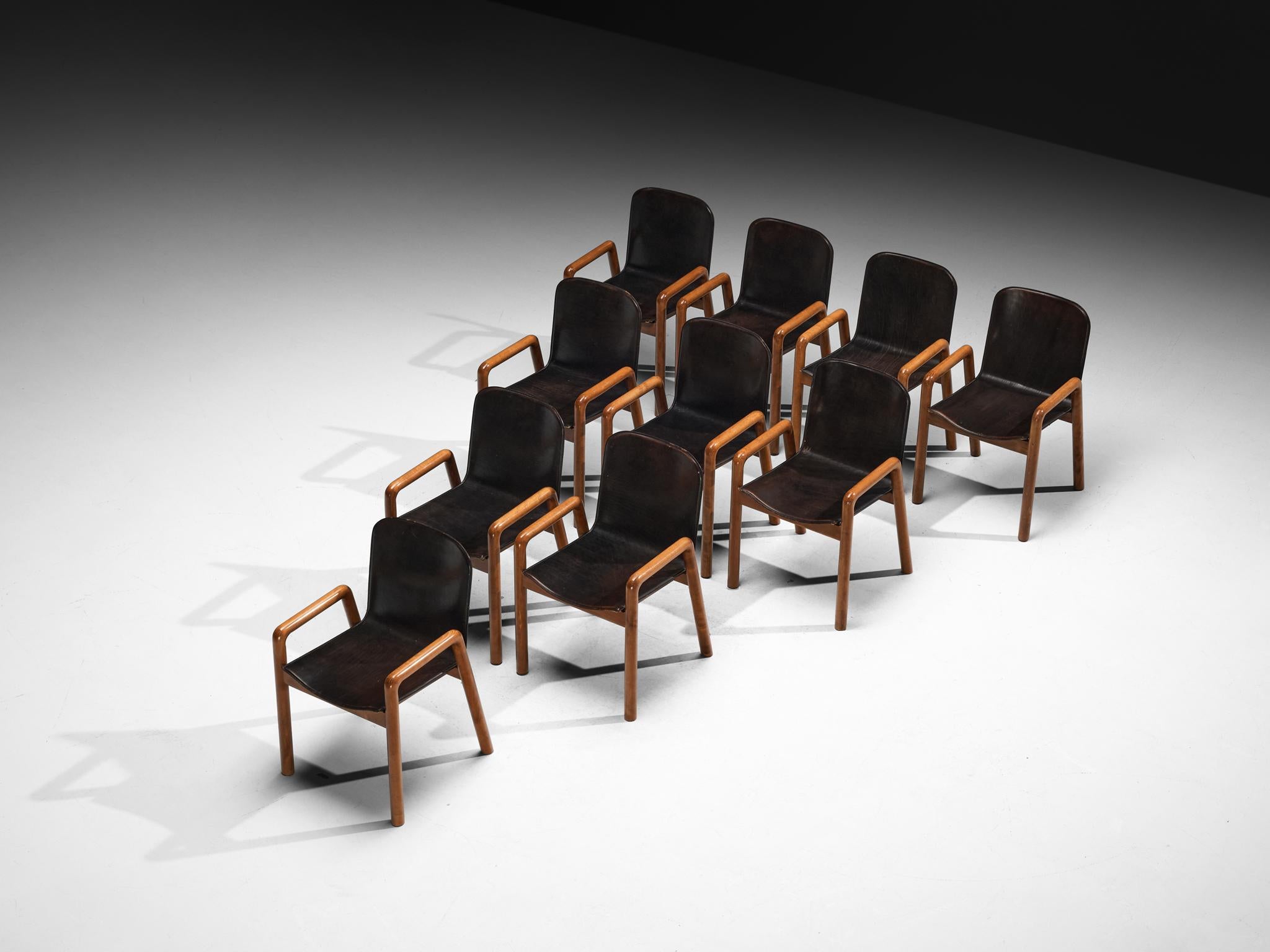 Set of ten dining chairs, leather, beech, Italy, 1980s

Sturdy and elegant Postmodern dining chairs made in Italy. A strong characteristic of this design are the smooth constructed armrests and round contours visible in the leather seats. The brown