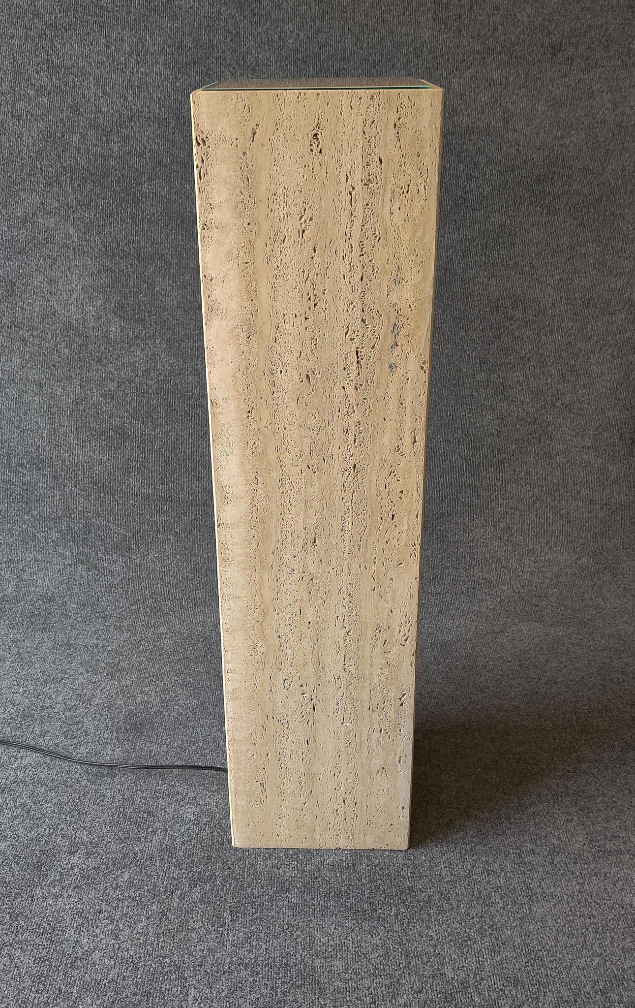 Simple, sleek, elegant and well-made - an illuminated travertine-marble pedestal. This pedestal was made in Italy in the mid to late 1970s and retailed in the US by the famous retailer Maurice Villency. It very good used condition, with original