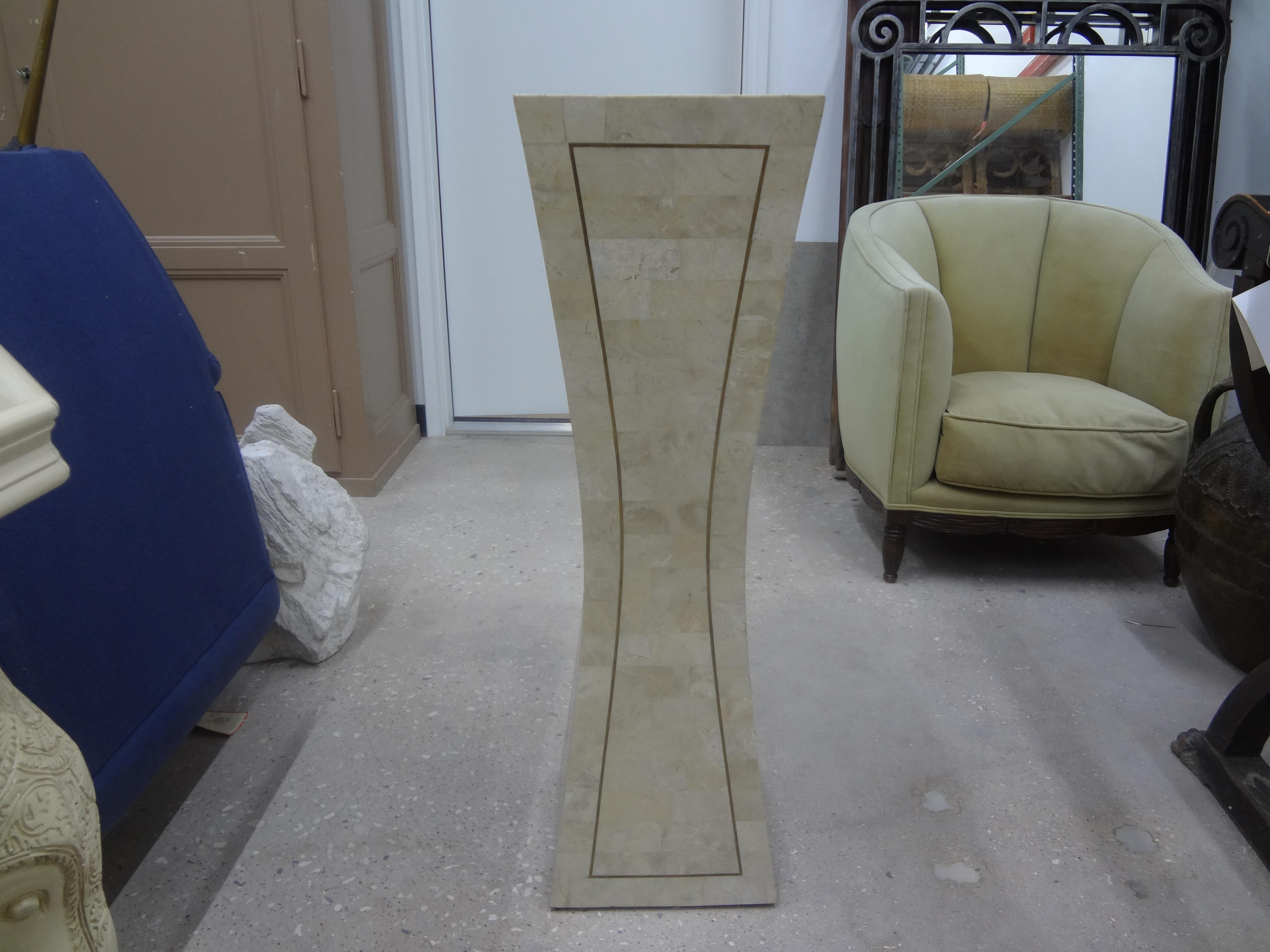 Large tessellated stone and brass pedestal.
This shapely postmodern pedestal is perfect for a sculpture, bust or vase.