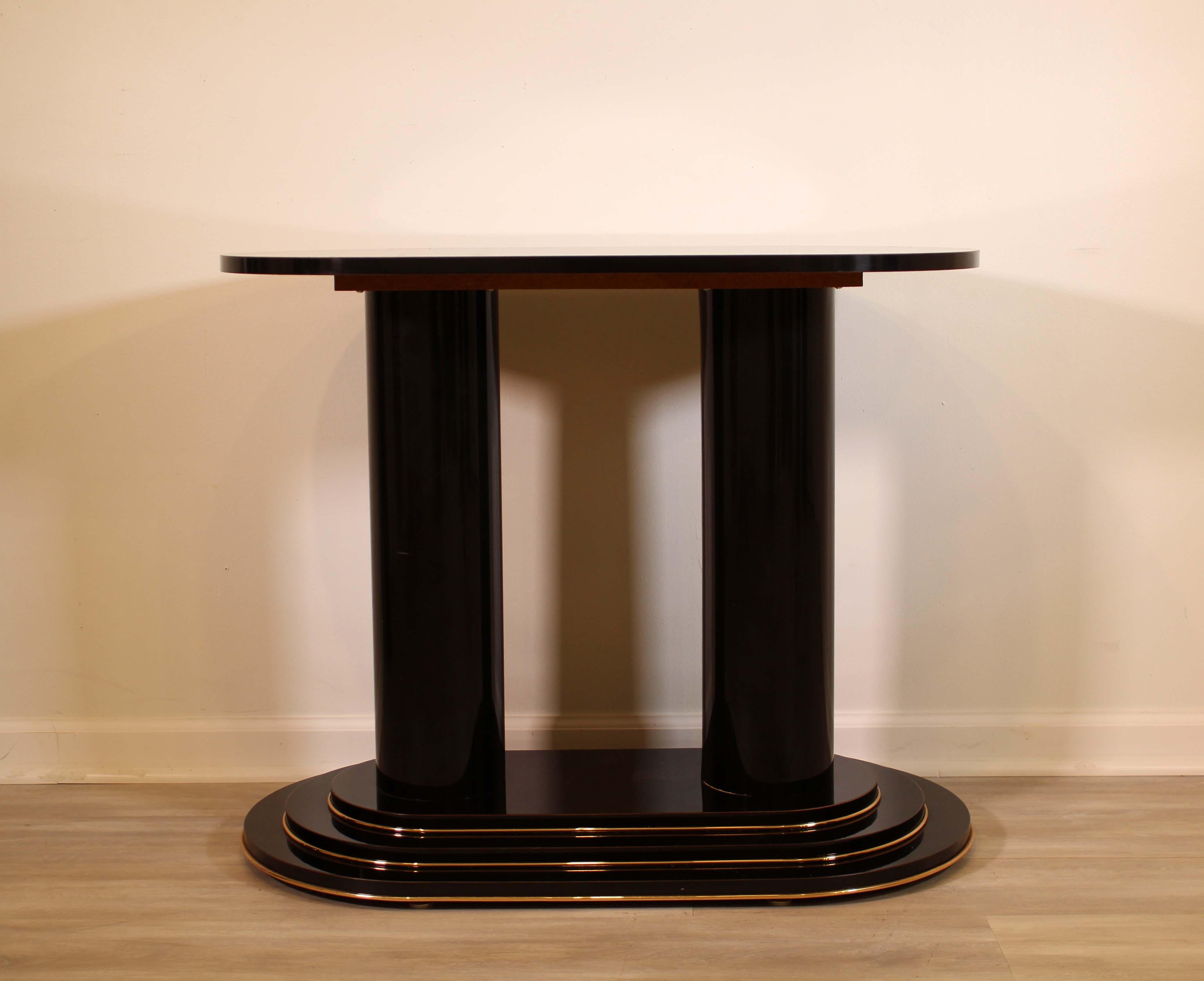 A sleek, black lacquer and brass accents console table or sofa or foyer table. In very good condition. Dimensions: 35.75