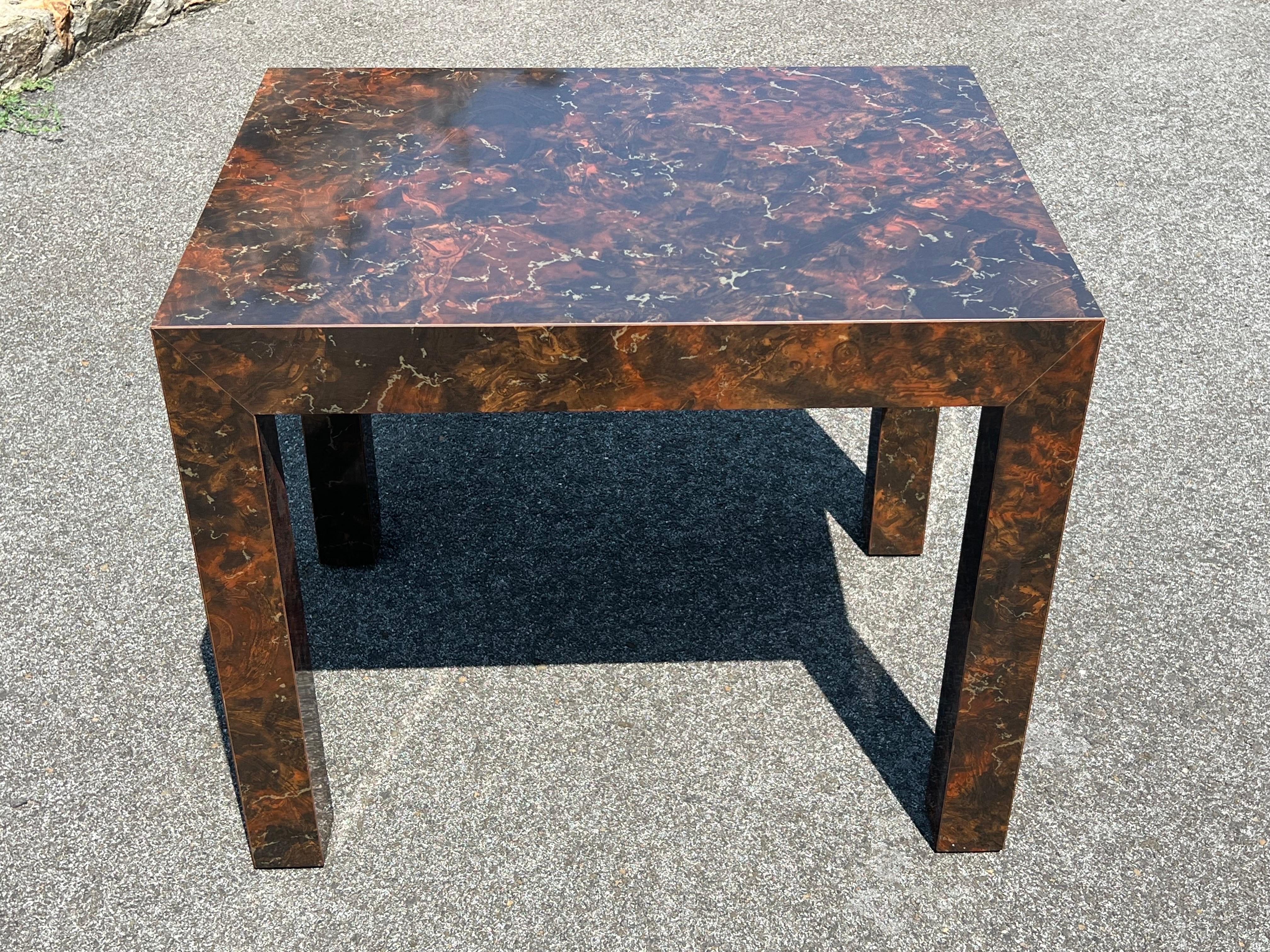 Post Modern Laminated Tortoiseshell Table. Rich deep brown earth tones with speckles of gold and orange and vein like bands of off white. Use aa an end table. We also have a matching sofa table, coffee table and larger end table.