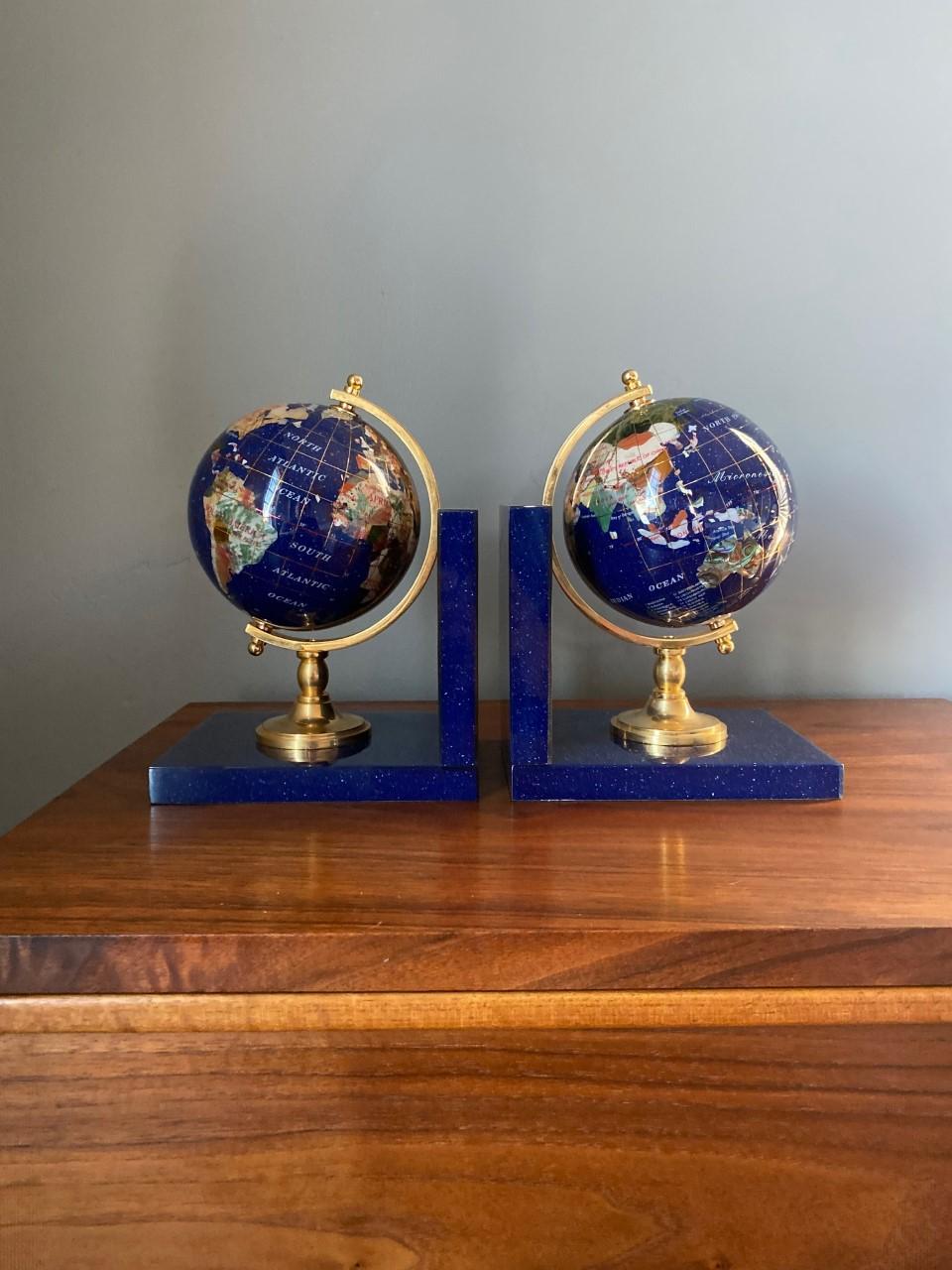 Enticing pair of Globe bookends. Channeling old-world glamour into your home décor, this captivating set of two bookends will add chic, style and uniqueness to your décor. The base for each bookend is enveloped in lucite that allows a lapis finish