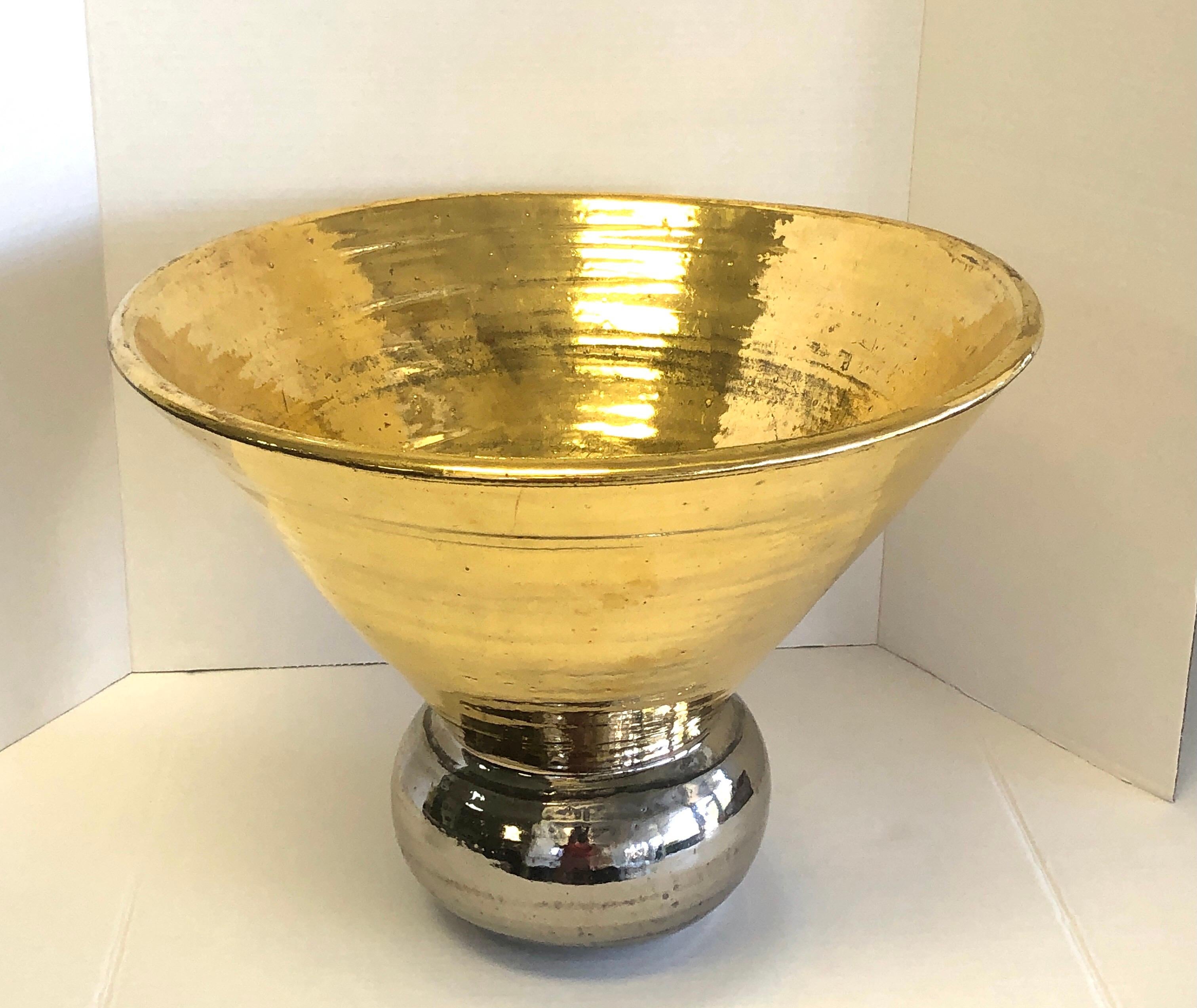 A very large ceramic bowl. Gold and silver glazes. Signed under base.