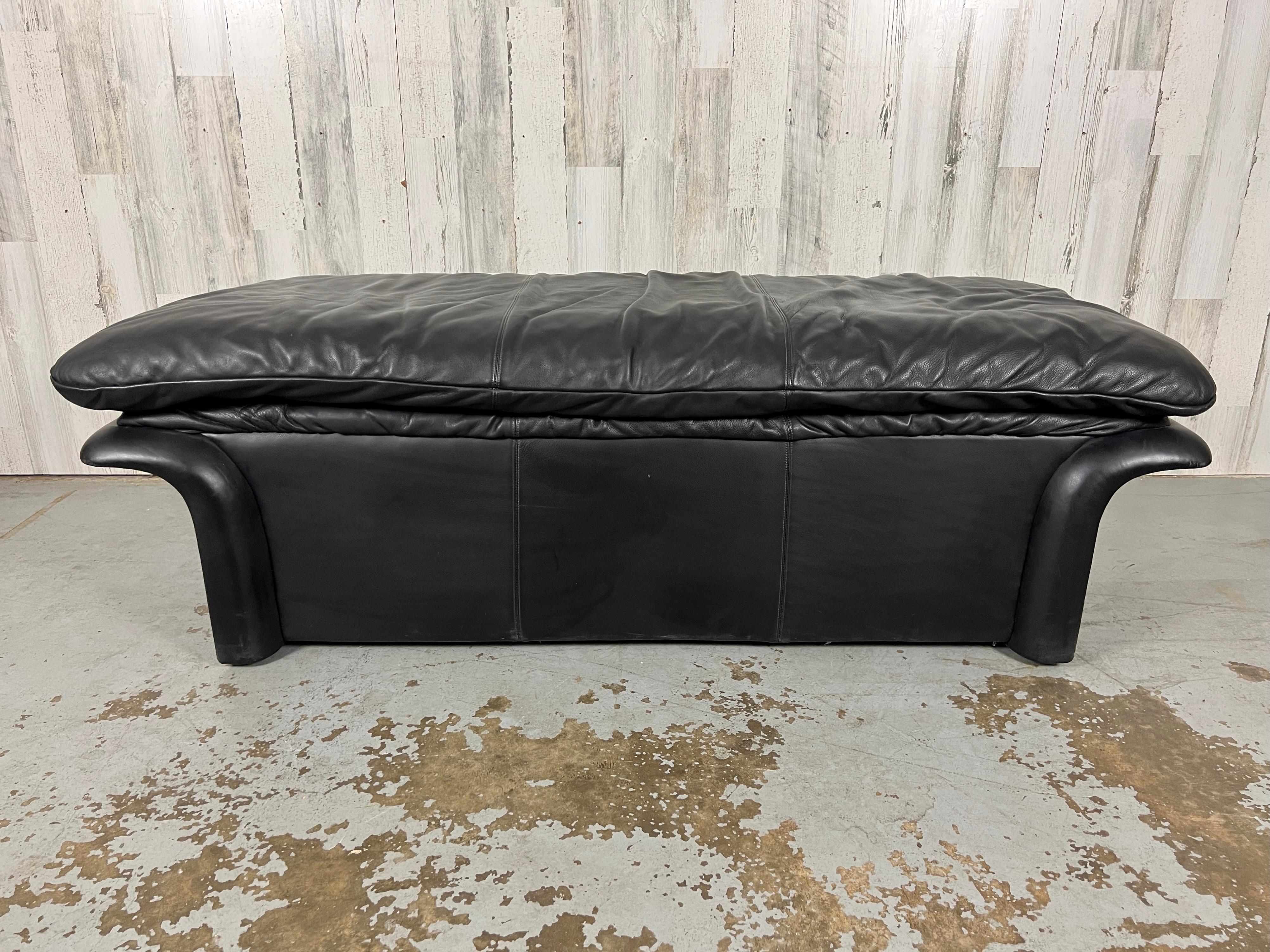 Post Modern black leather bench with curved handle ends.