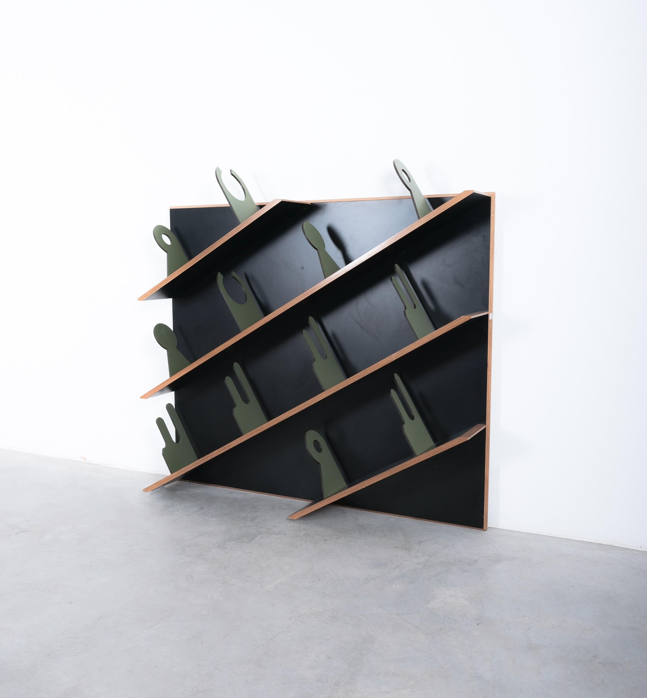 Graphical shelf system, Italy circa 1980

Very rare suspension, wall mounted shelf for large books. Well-sized black shelf with lots of space for especially larger books. It looks very cool and is very practical at the same time. The green spacers