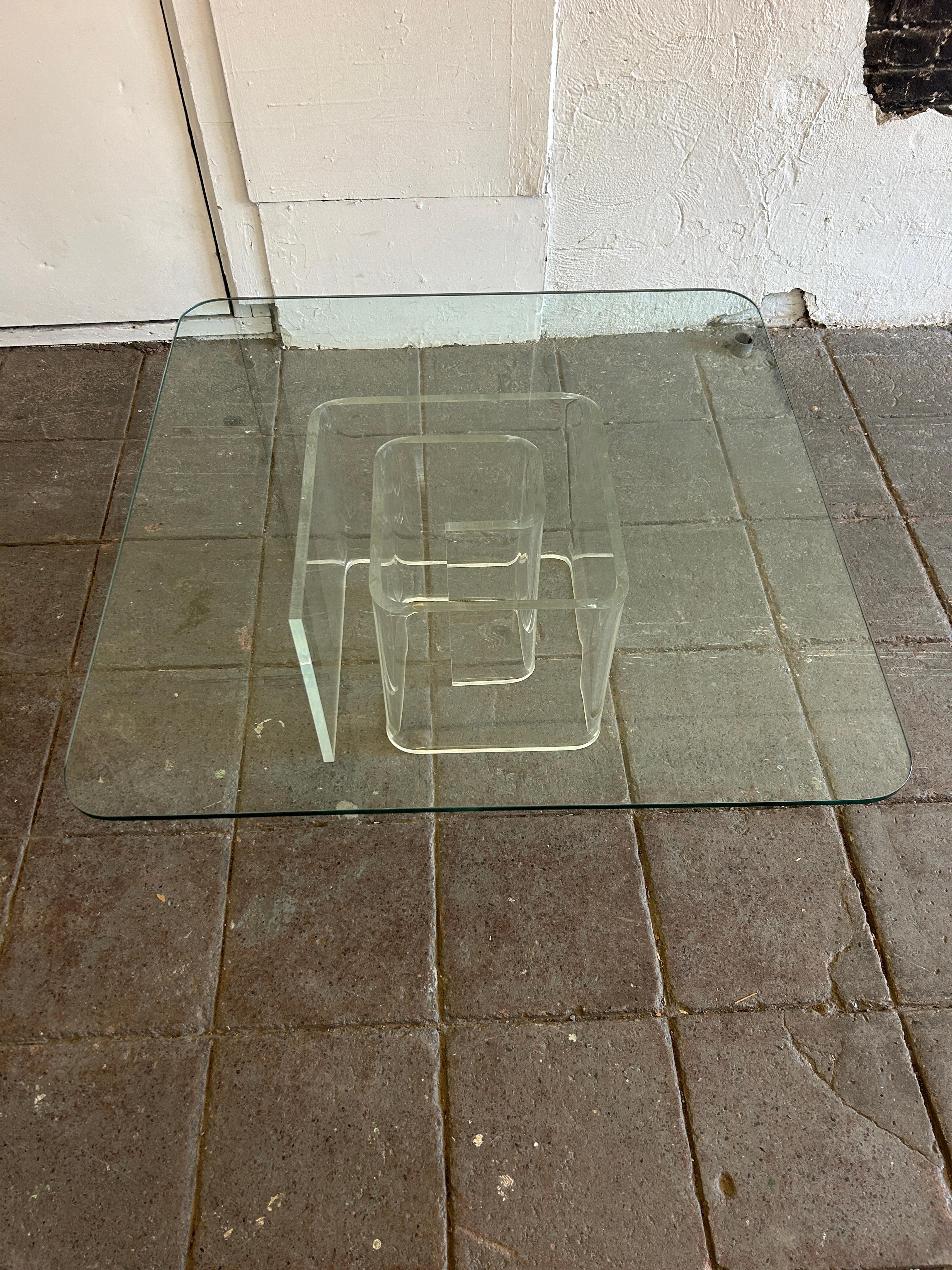 Post modern lucite snail spiral glass top coffee table. Base is made of clear polished lucite abstract form. High quality rounded corner glass top coffee or cocktail table. Very clean all around. Very little light scratches on glass. Ready for use.