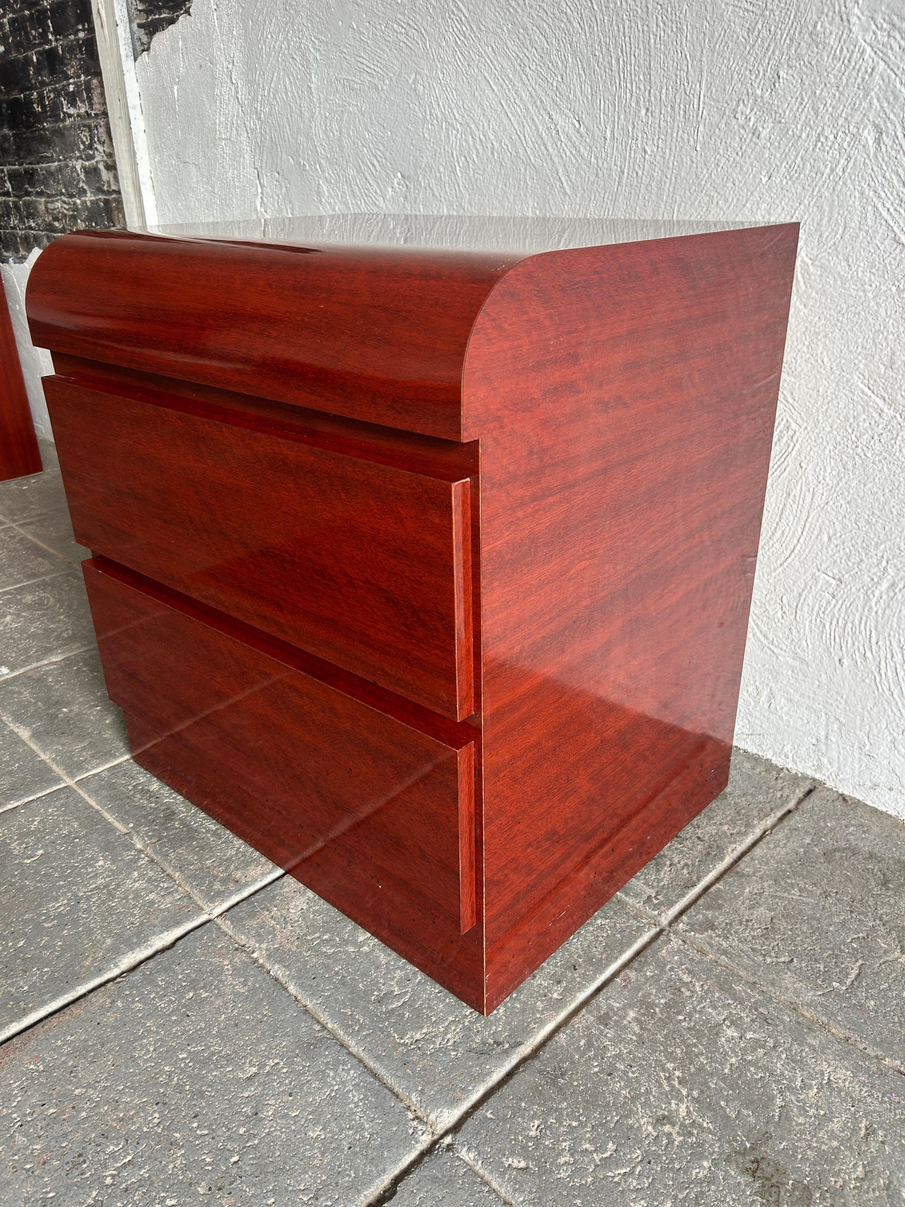 Beautiful post modern faux mahogany wood grain gloss laminate waterfall front 2 drawer nightstand, circa 1980. Very clean inside and out. Look at photos. all drawers have metal glides with stops. Great for home, office, art studio/gallery or retail