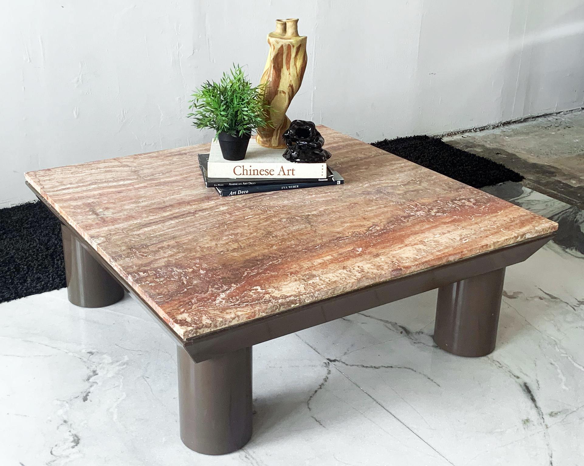 Available right now we have this gorgeous post-modern coffee table in the style of Mario Bellini. This marble coffee table features a brown lacquered base with chunky rounded legs, super Mario Bellini style, with an almost pyramidal tapered mid-body