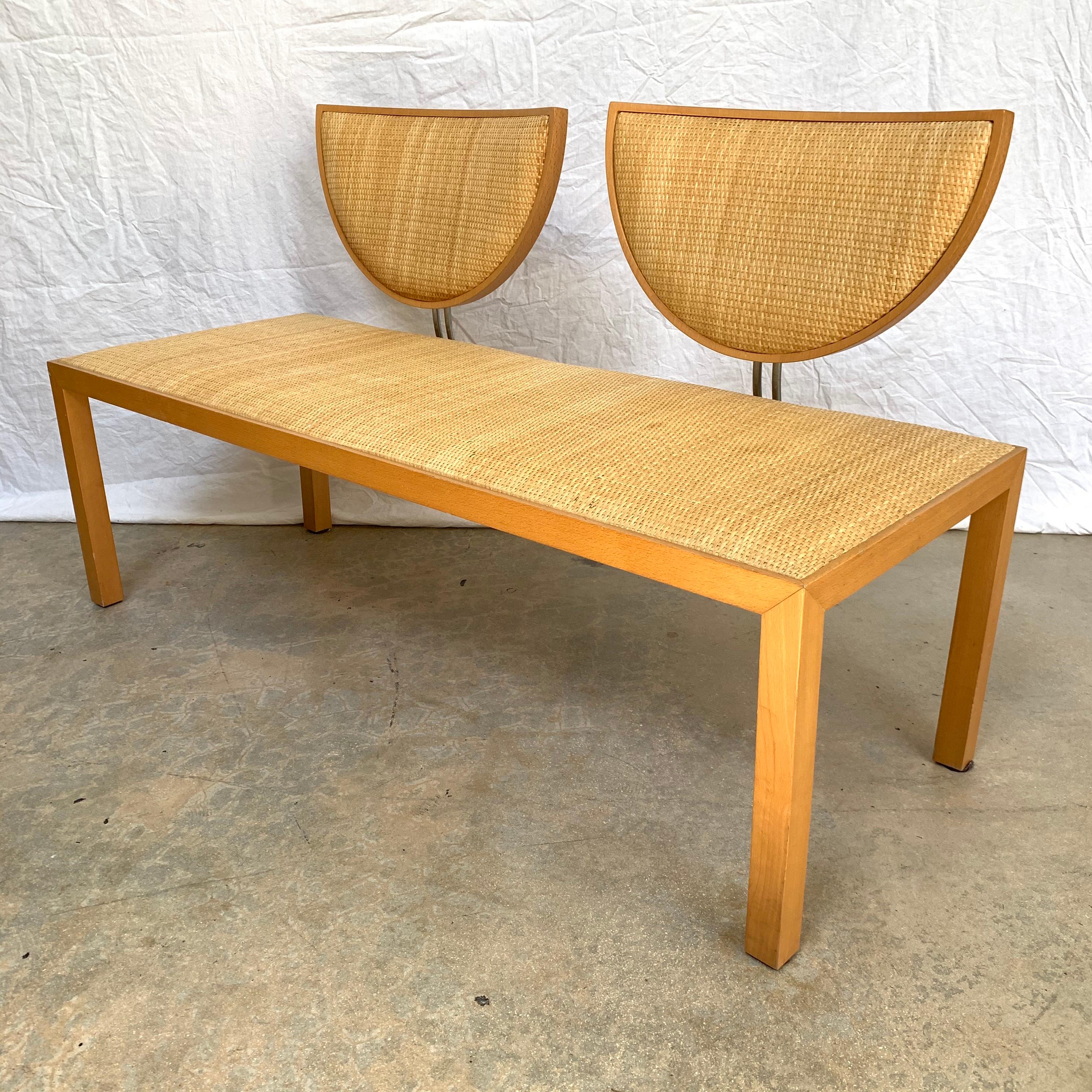 Postmodern bench or settee rendered in a square parsons oak frame with raffia seat and back upholstery and two bak rests supported by bent chrome plated steel, style of Memphis Group, circa 1980’s