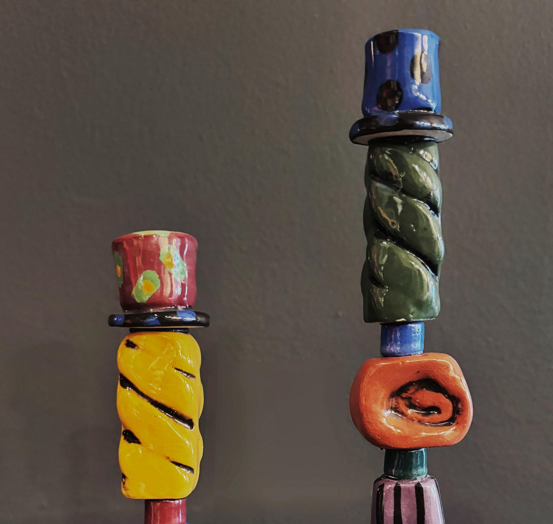 Post Modern Memphis Milano studio pottery  Candlesticks

Offered for sale is a pair of post-modern studio pottery candlesticks created in the Memphis Memphis Milano style. Each candlestick is artist-signed Mueller ‘97 under the base.  They are