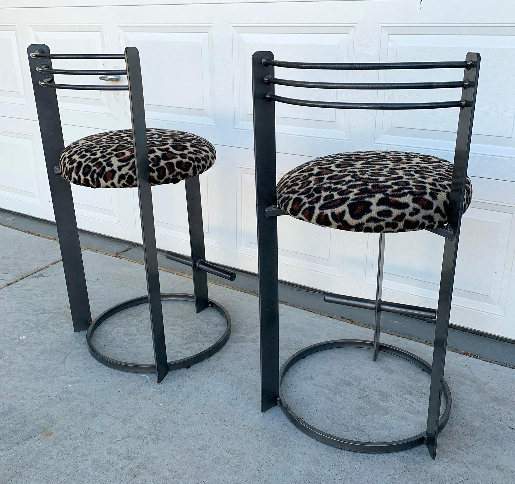 A stunning set of post-modern style bar-stools that just ooze Postmodern cool. These Memphis Milano style bar stools are upholstered in a cheetah patterned print (re-upholstery available at a nominal fee).

These stools are substantial and heavy,