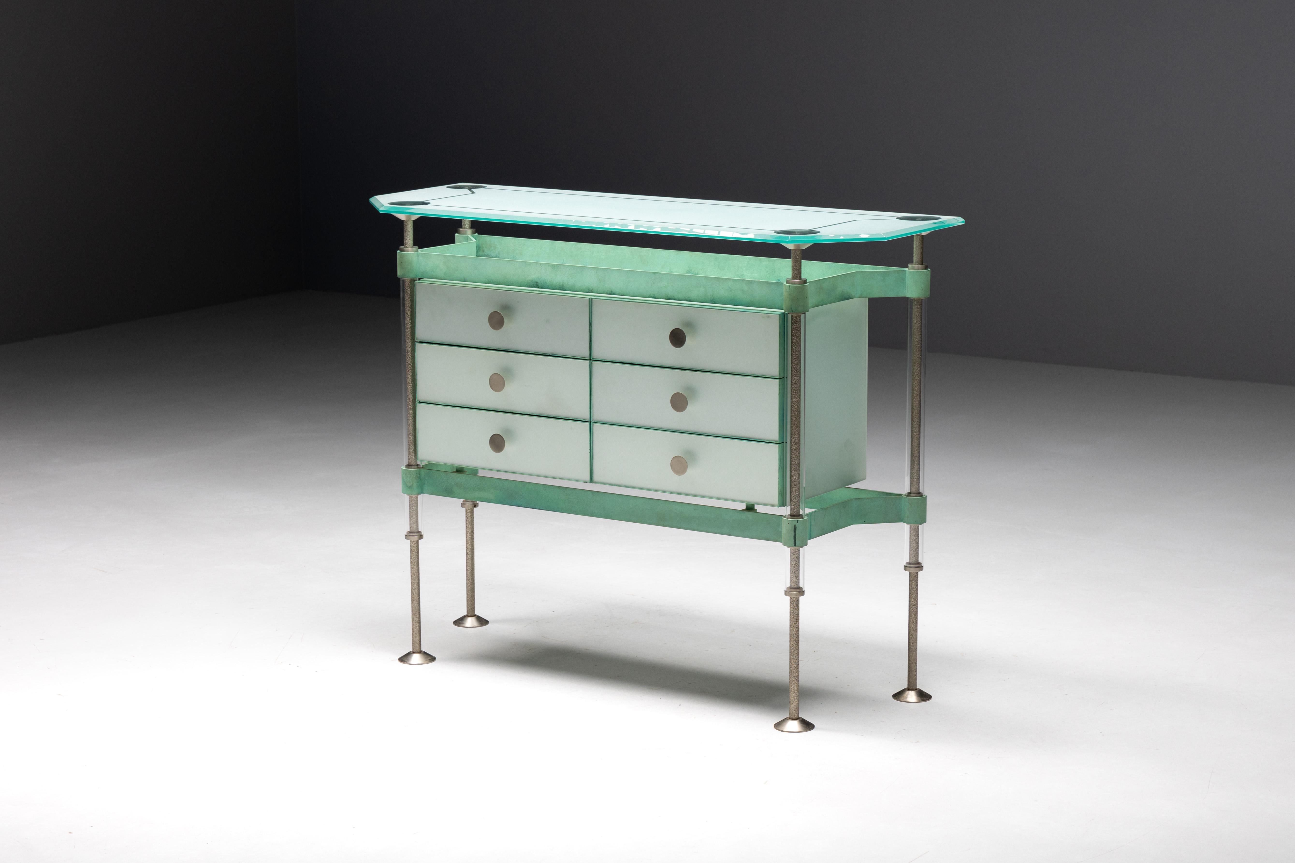 Commode by De Coene, a Belgian masterpiece crafted from a unique blend of materials including glass, oxidized copper, and stainless steel. Originally unveiled at the Kortrijk Expo in 1988, this cabinet is a true collector's item, representing the