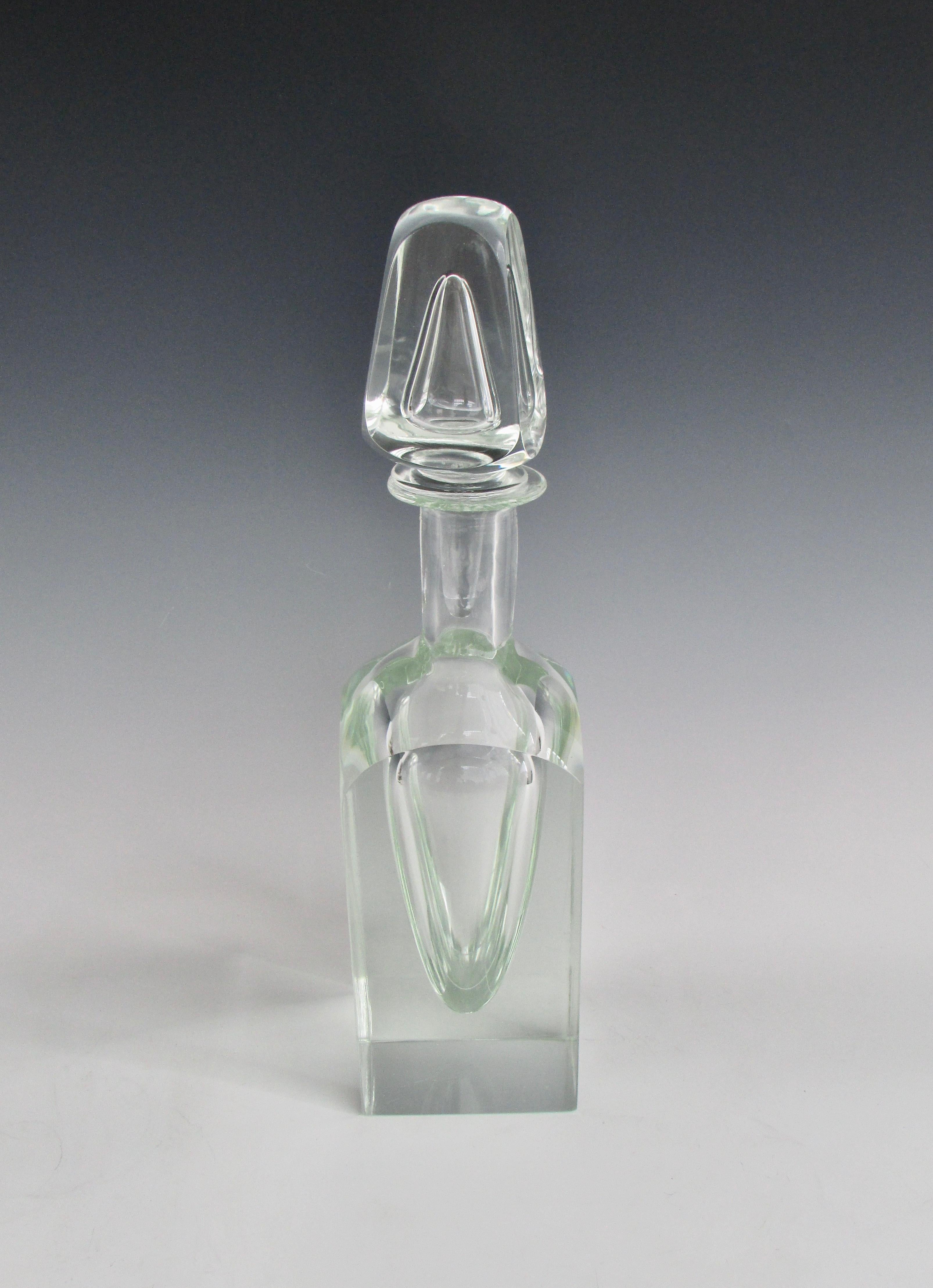 Large substantial piece of clear glass with equally impressive stopper. I see a strong post modern Memphis Milano look.