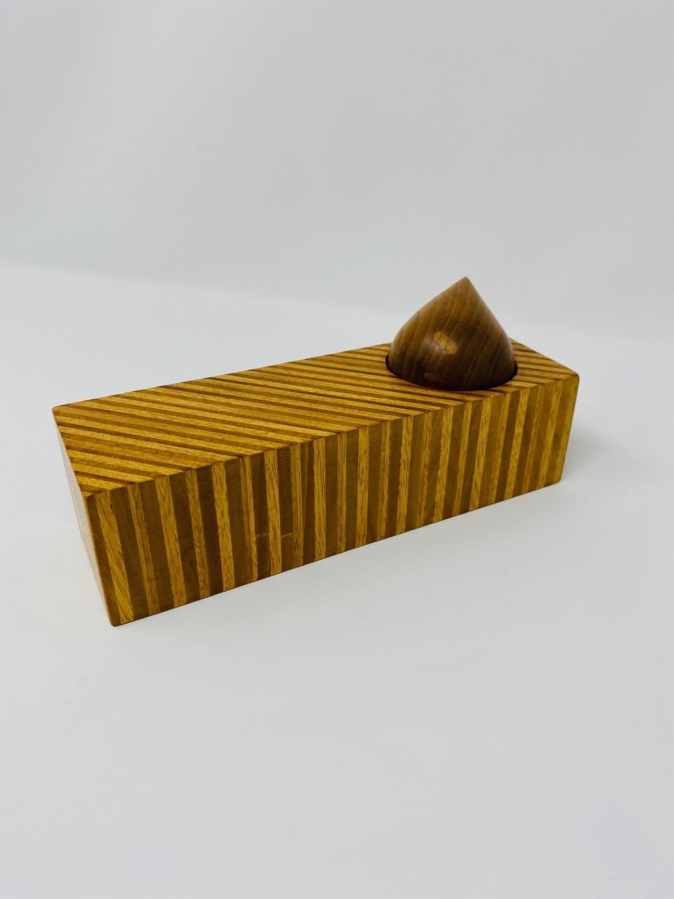 Postmodern Memphis style mixed wood trinket box in the style of Russ Keil, circa 1980s. The box is 7.25