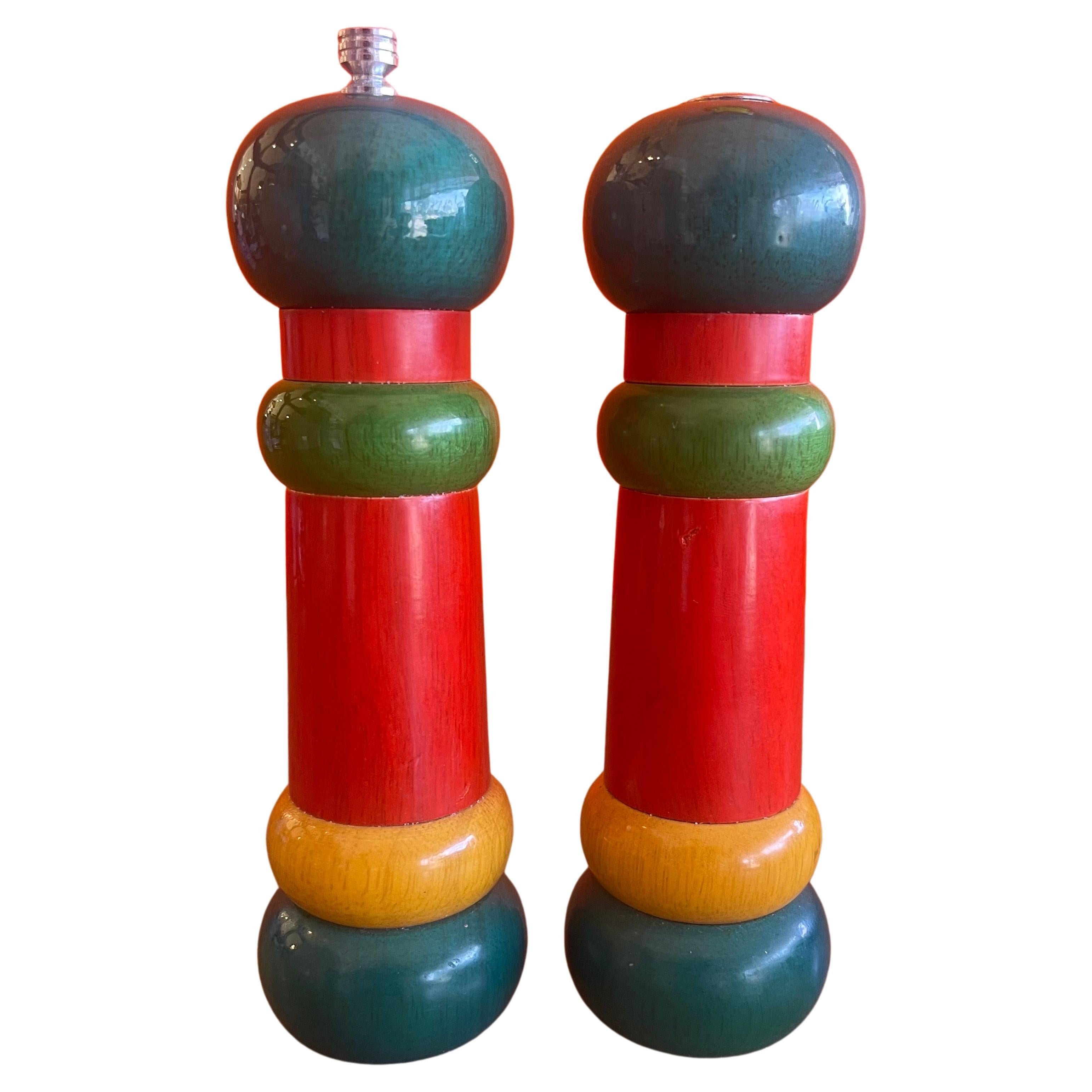 A very nice pair of post-modern Memphis style salt and pepper shakers by Olde Thompson, circa 1980s. The set is constructed of hard wood with colorful high lacquered paint. The pair are in very good condition and measure 2.25