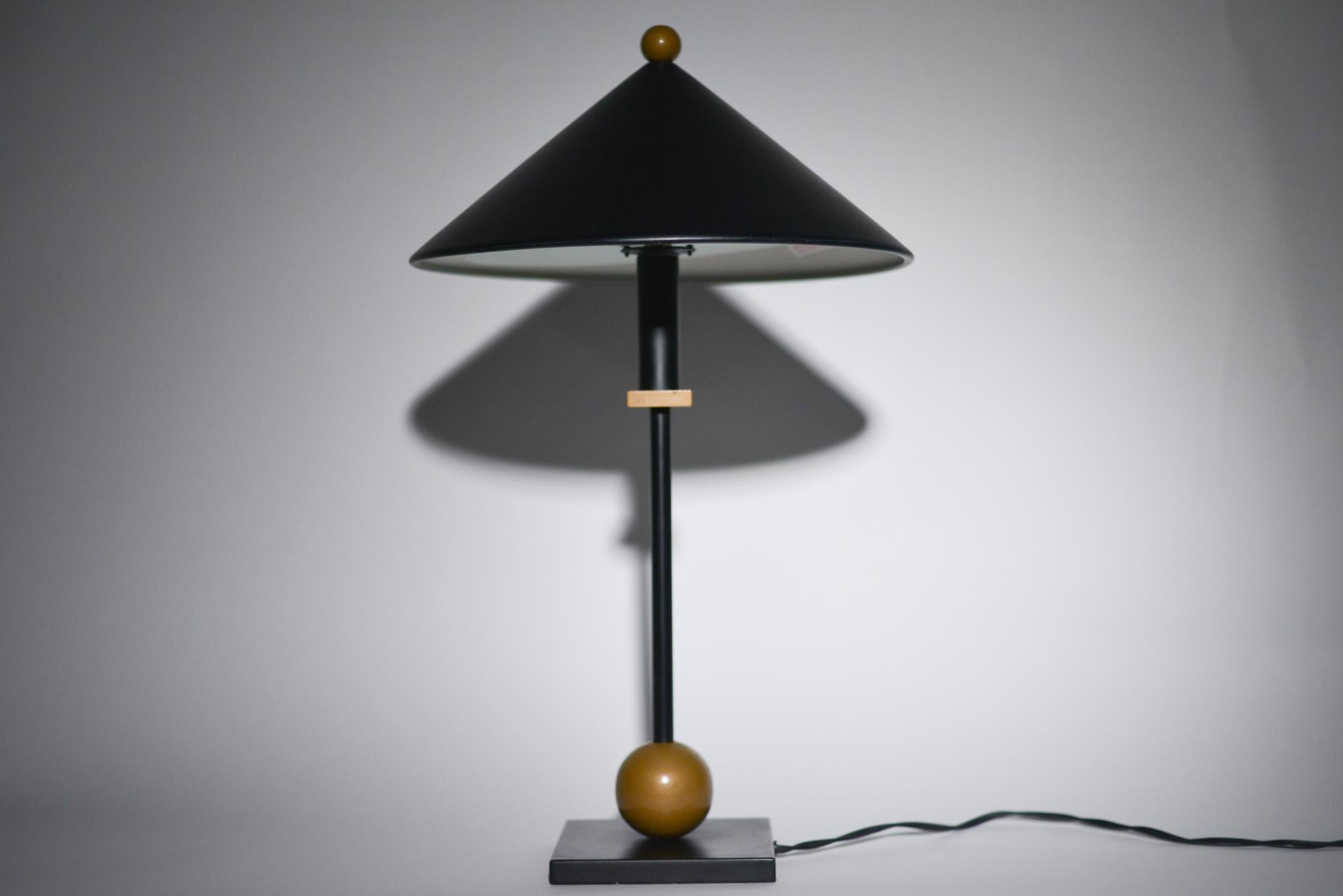 Lighting designer Robert Sonneman designed architectural and decorative lighting that captures contemporary American living. The metal cone shade and geometric brass finishes of these post modern lamps creates a functional and playful design. A