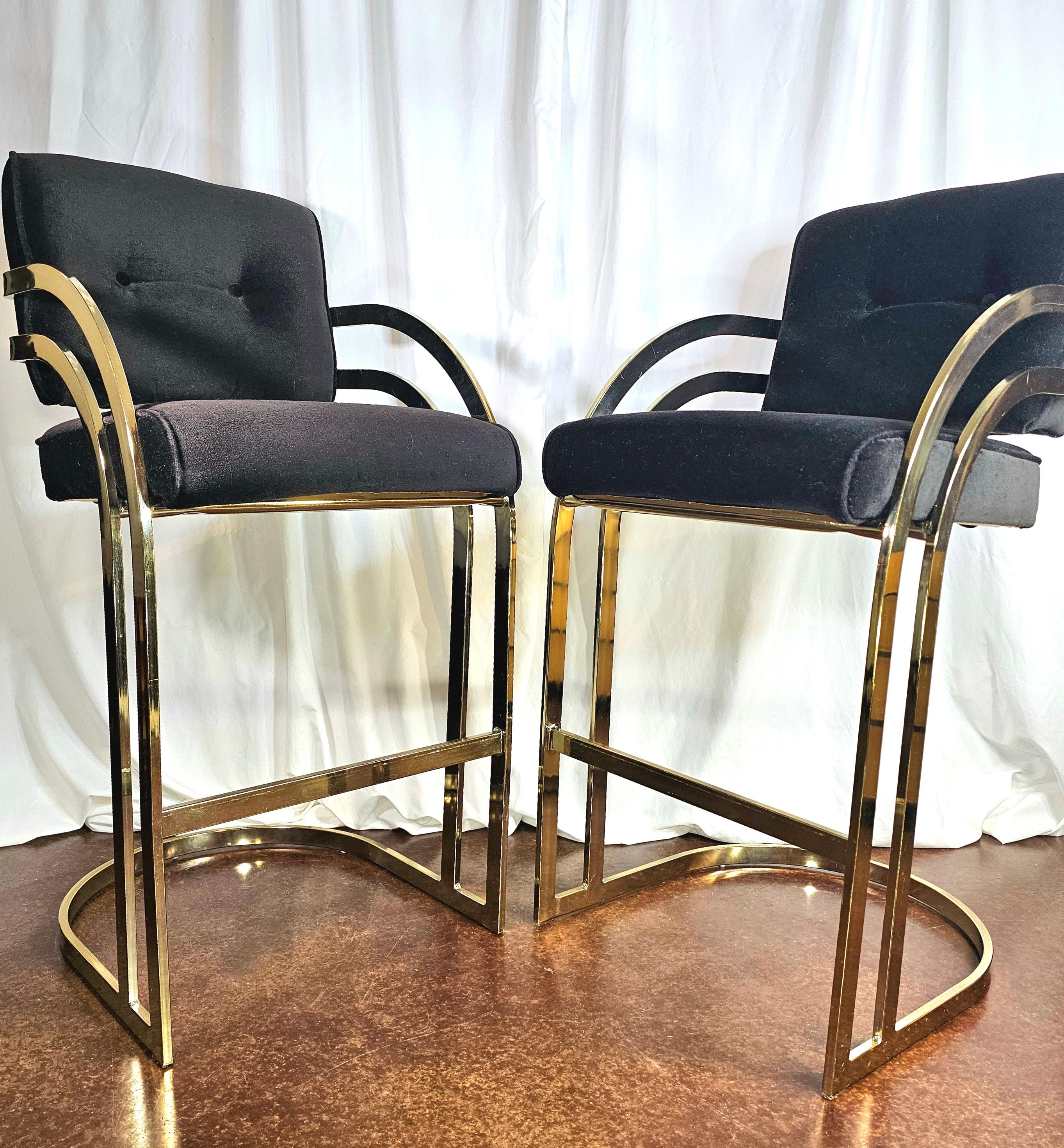 Year of birth 1975

Iconic styling for the time.
Very Milo Baughman. 
Very Saturday Night Fever. 
Vintage upholstery is in amazing shape. 

Stunning pair of vintage modern bat height barstools.
Feature a stylish cantilever brass plated frame with