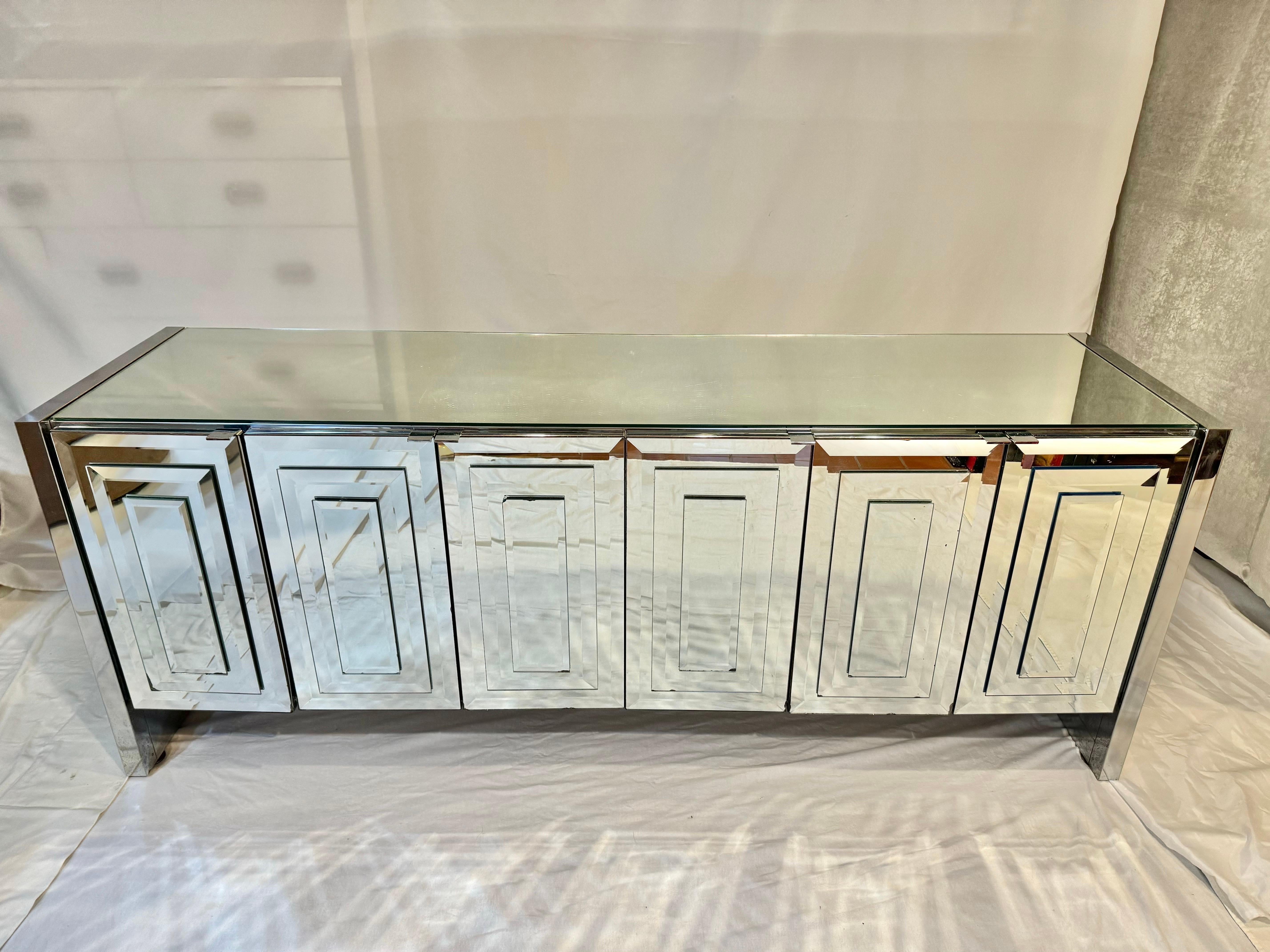 Post Modern Mirrored Credenza by Ello. This is the “Reflections” line from the 1980’s by Designer O.B Solie. Fabulous six door beveled mirrored piece to illuminate your room. Use as a dresser or credenza . The doors open up to white laminate