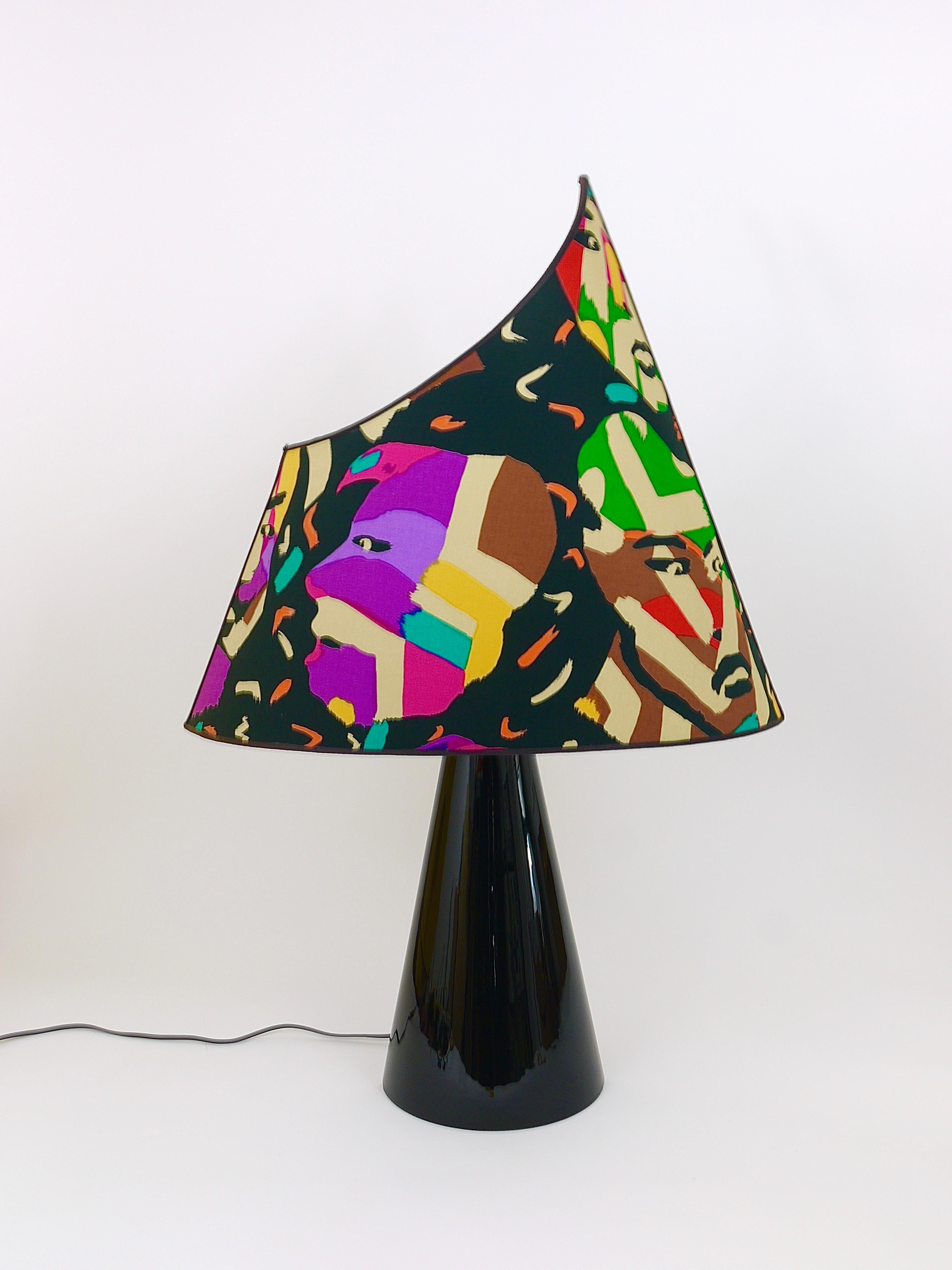 An amazing colorful postmodern Missoni table or side lamp from the 1980s, designed by Massimo Valloto, executed by Ceramiche Viba, Bassano, Italy. This light has a conical unusual ceramic base with black shiny glaze and an asymmetrical lampshade in