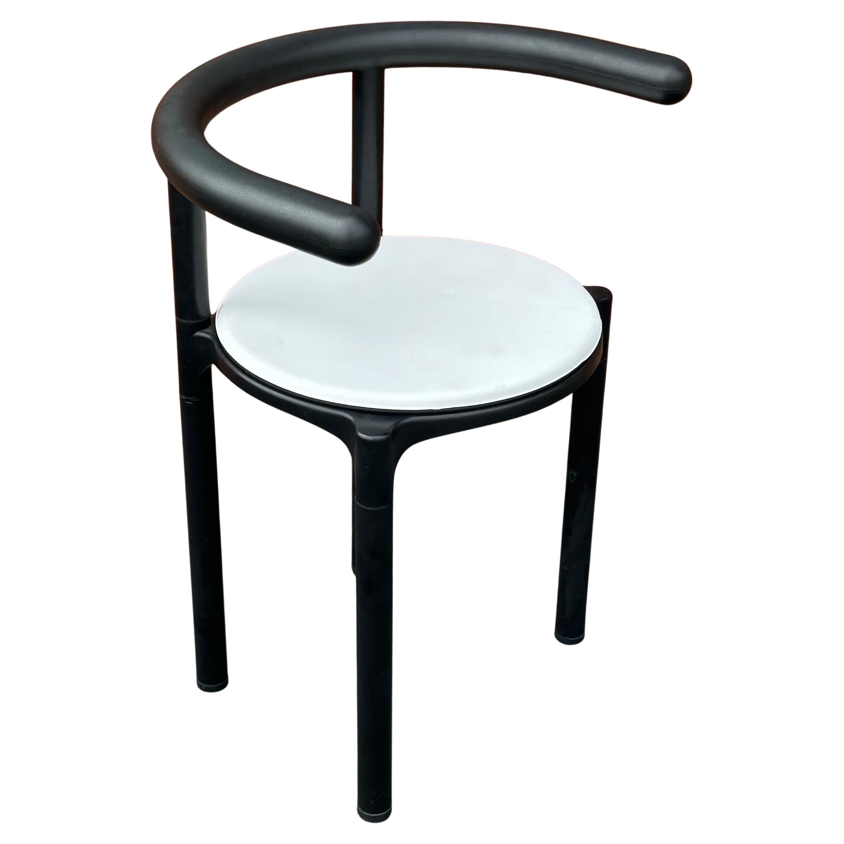 Cool post-modern Model 4855 armchair chair by Anna Castelli for Kartell, circa 1990s.  The cockpit shaped structure has curved armrests with a round midsection and detachable section legs and a white seat cushion.  The chair is in very good vintage