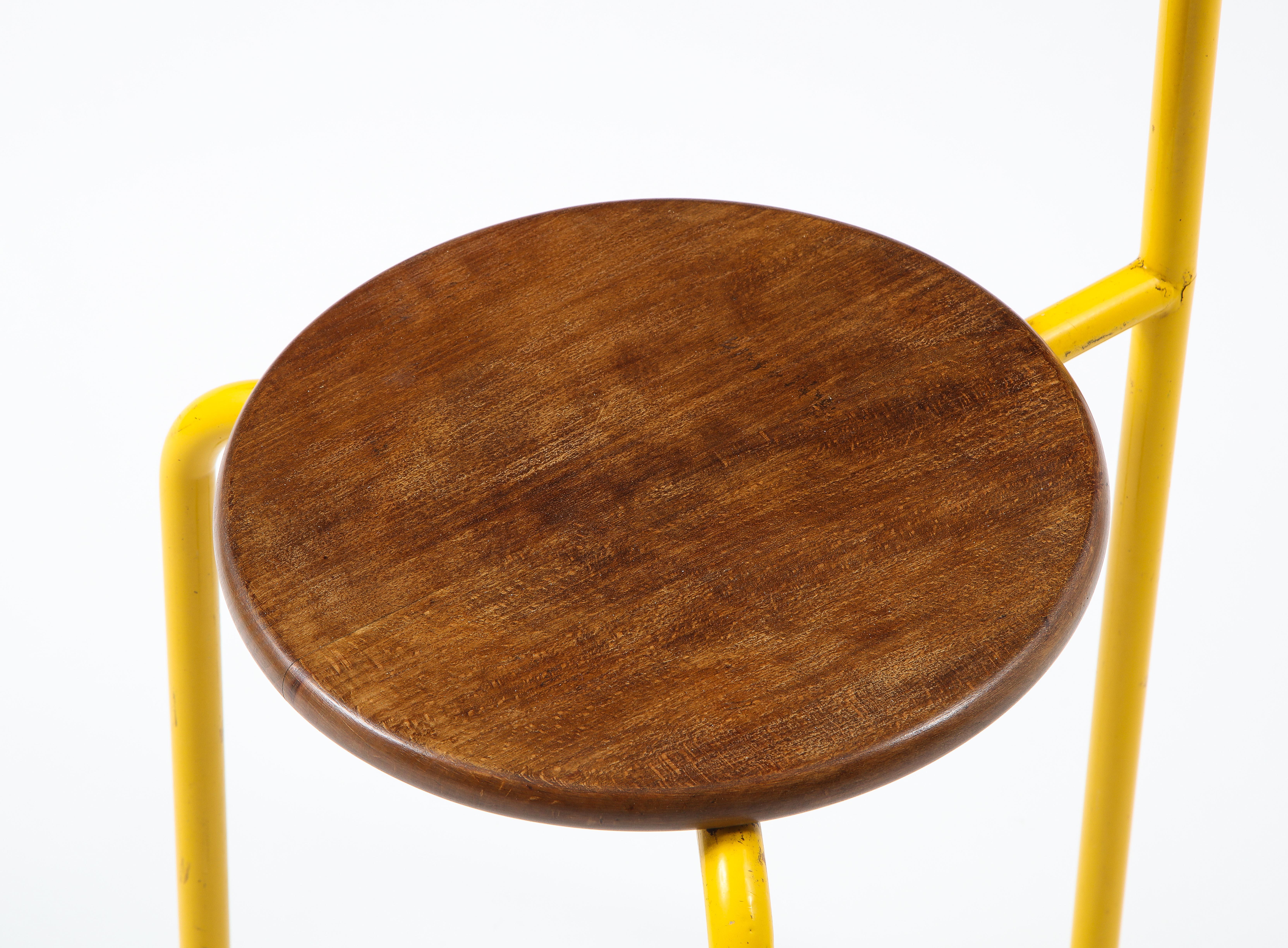 Post modern tripod chair in yellow enameled steel with an oak seat and accents.