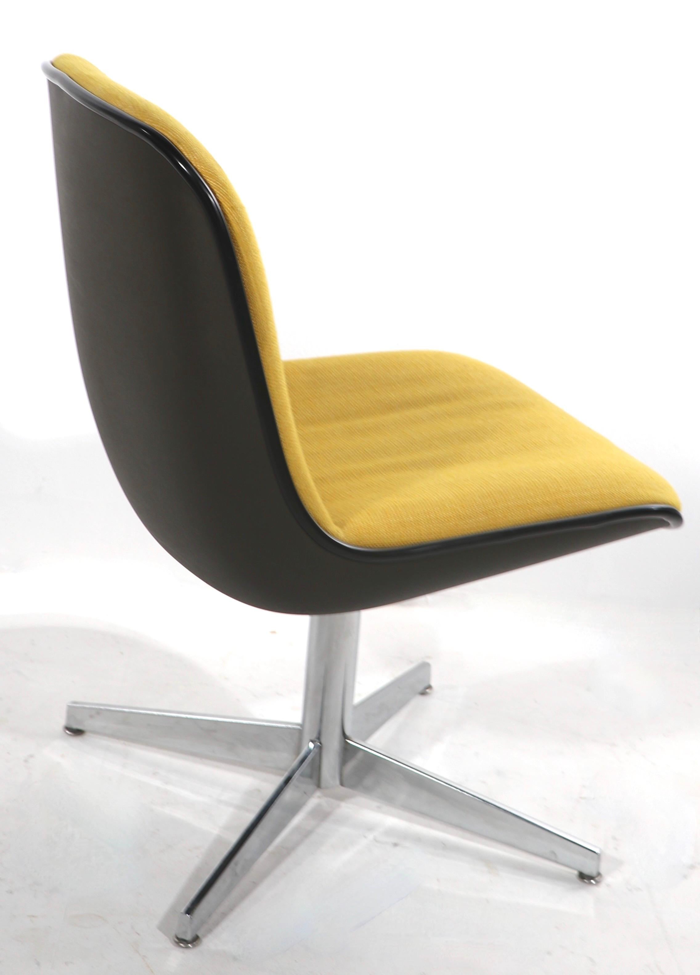 Chic architectural, ergonomic design office, side desk, dining chairs by Steelcase. The chairs feature yellow tweed continuous seats and backs, with dark gray plastic shells, on chrome base and lags. The chairs are stationary, ie they do not swivel