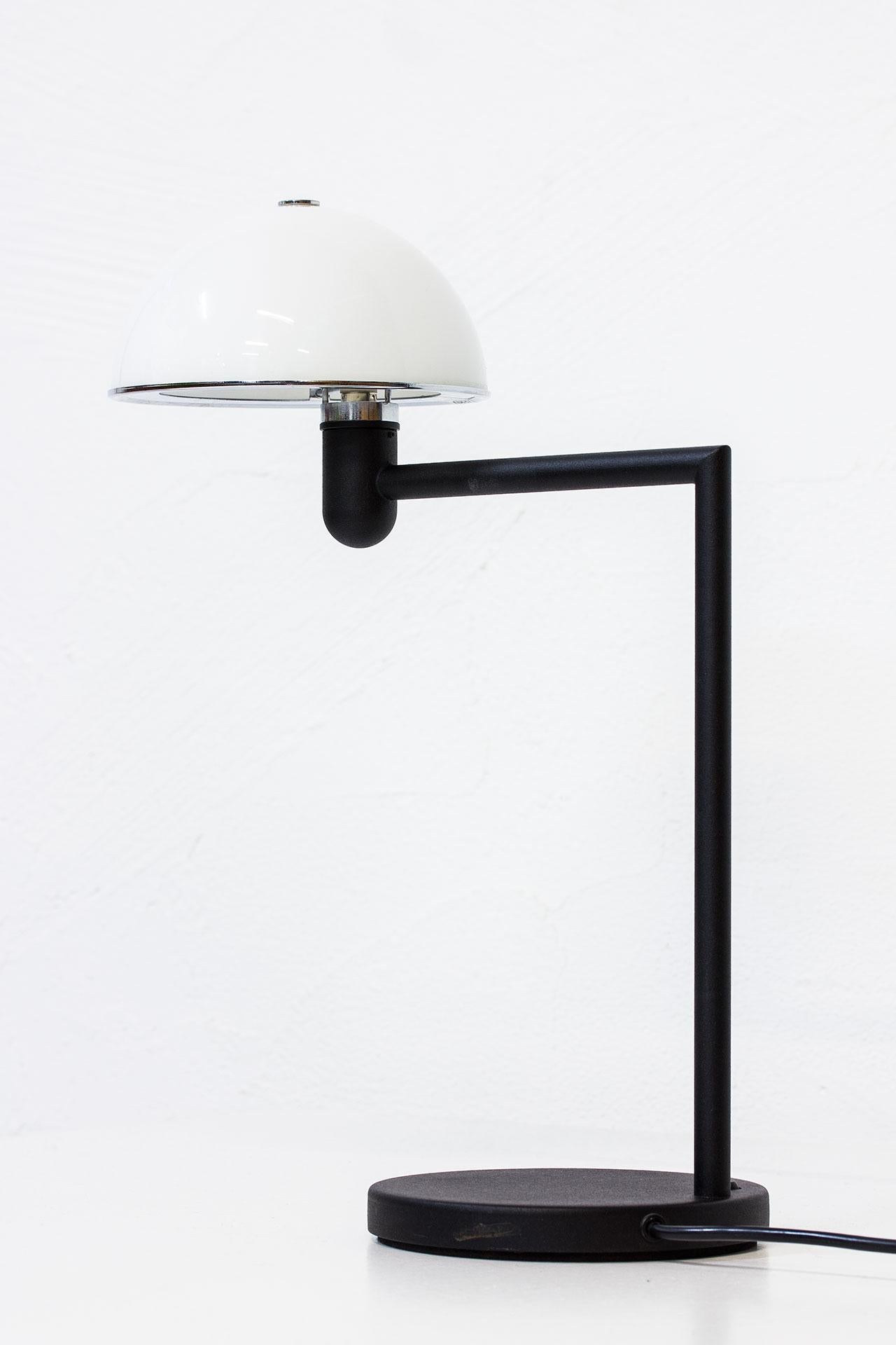 Table lamp designed by Per Sundstedt for Zero Interior in Sweden during the 1980s. 
Matte black painted steel stem with a white opal glass diffuser.
Light switch on the base.