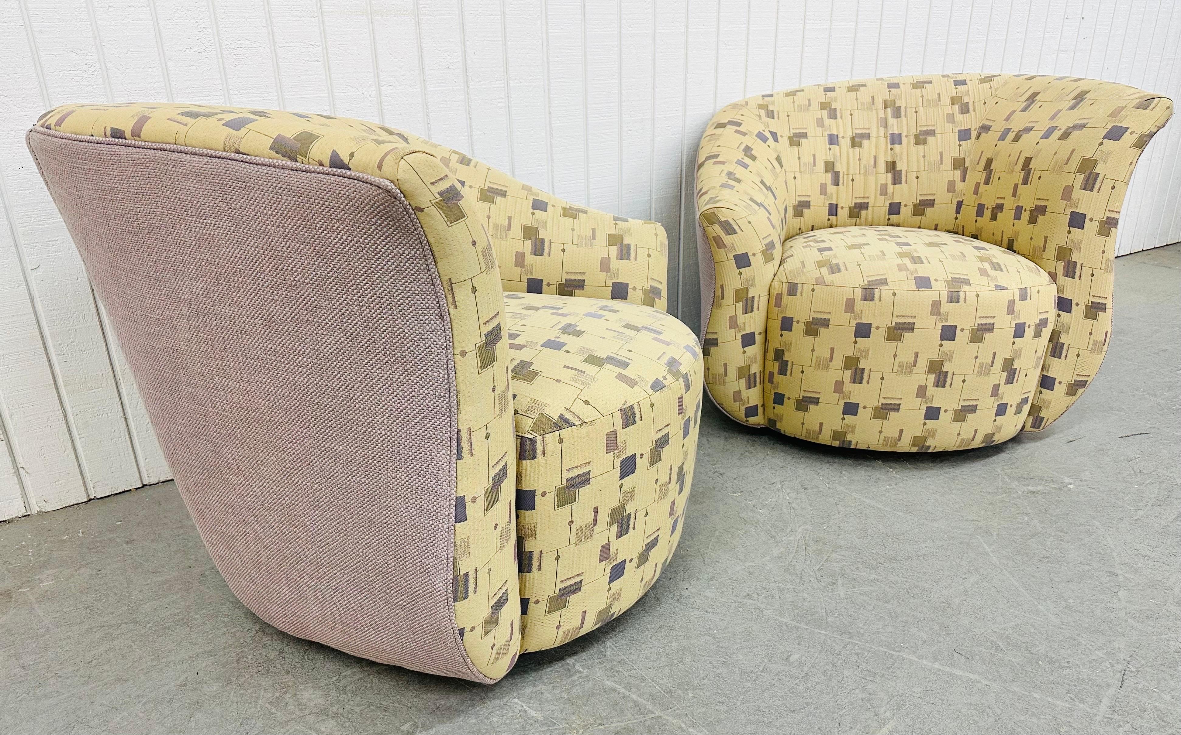 This listing is for a pair of Post Modern Oversized Swivel Chairs. Featuring a curved postmodern design, original geometrical upholstery, and the ability to swivel. This is an exceptional combination of quality and design in the style of Weiman.