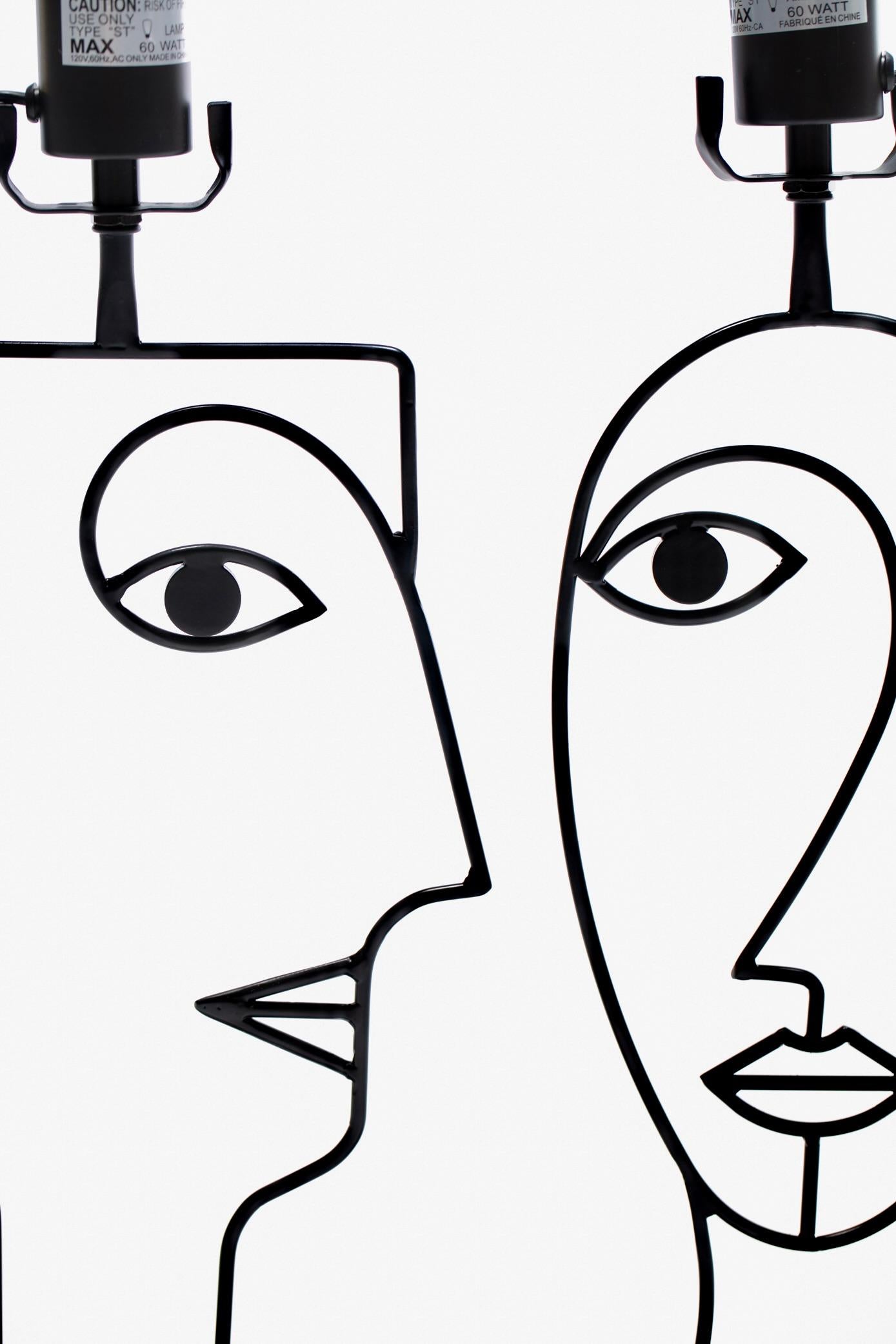 Alluring pair of Picasso inspired post modern facial silhouette table lamps. Modern. Eccentric. Similar in sculptural form to Frederic Weinberg pieces. Inject interest and curiosity into any space with this pair of black bent metal post modern face
