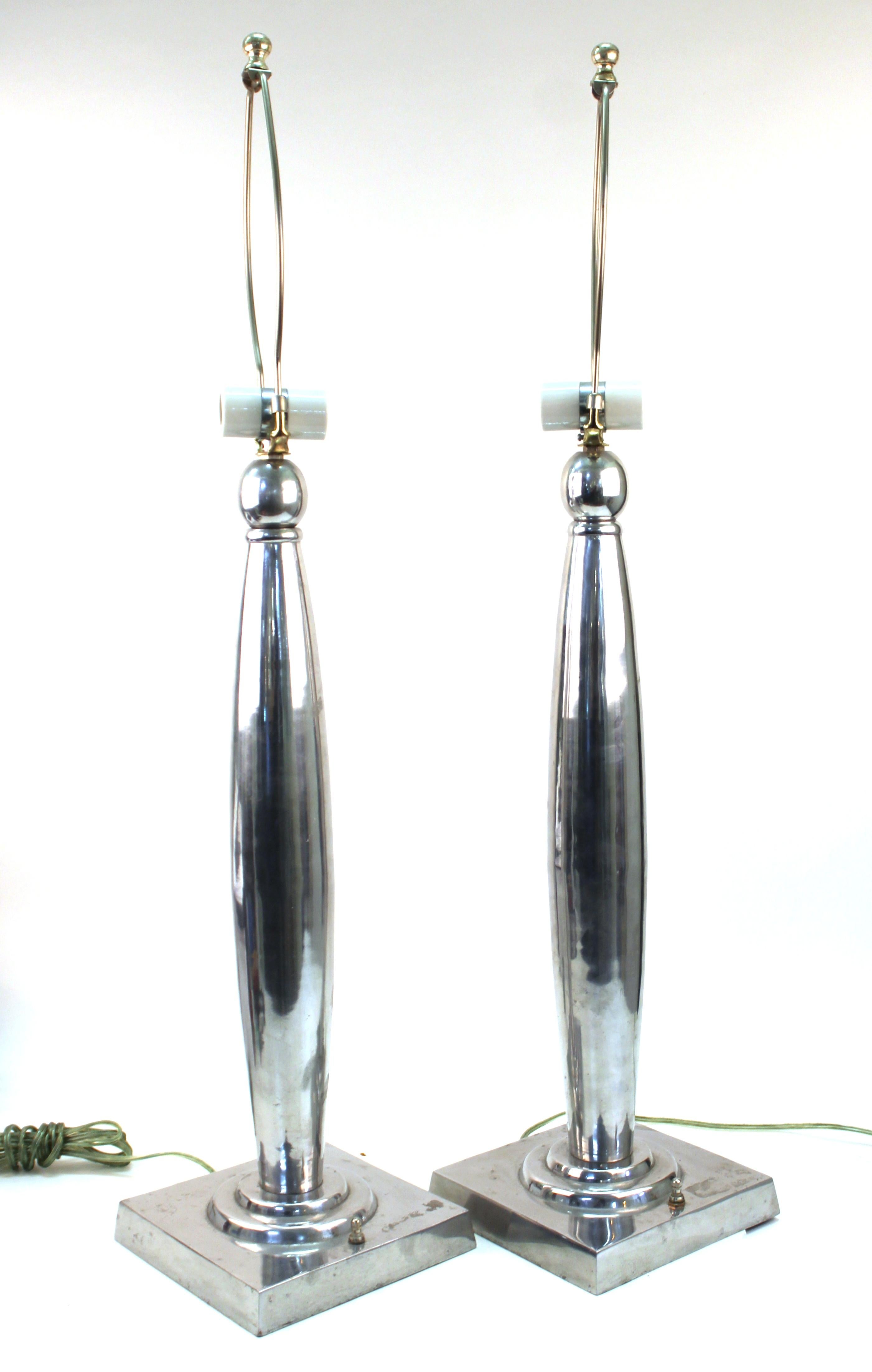 Postmodern pair of table lamps in polished aluminum. The lamps have two sockets each and were likely made in the late 20th century. In great vintage condition with age-appropriate wear and use.