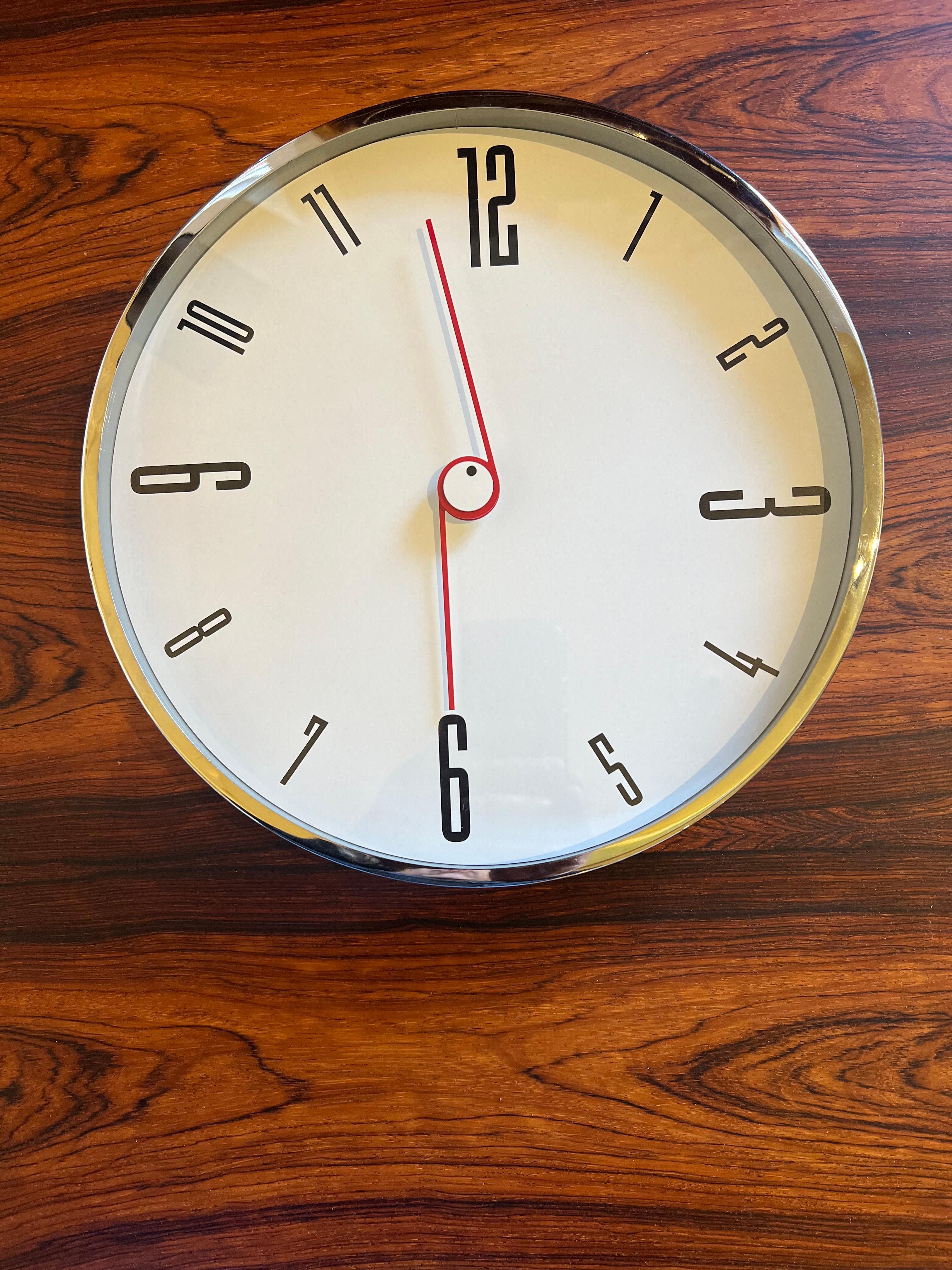 This very rare and collectible wall clock, circa 1980's a great postmodern design chrome plated frame and glass top unique piece nice handles battery operated.