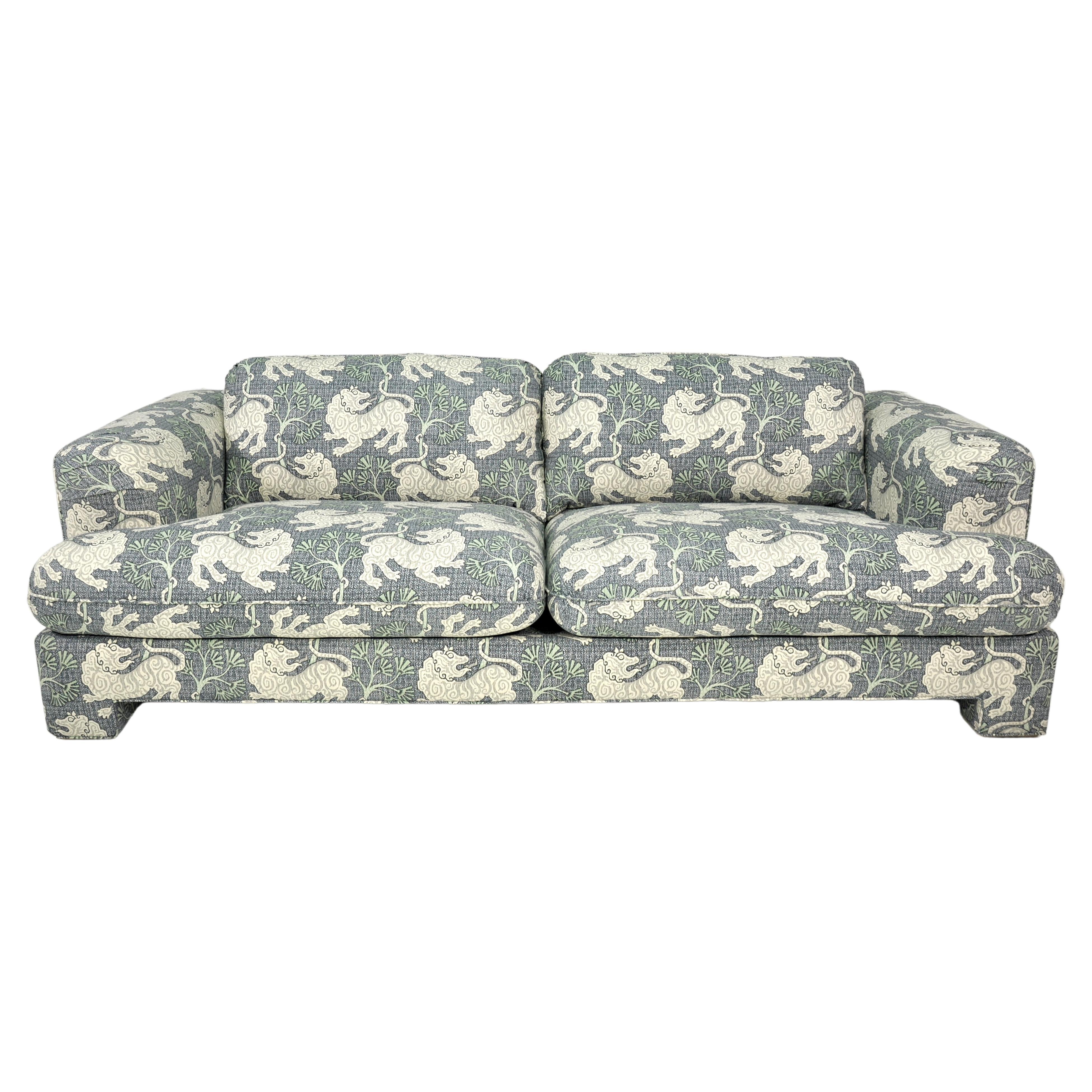 Newly reupholstered post-modern sofa by Roche Bobois. The overstuffed vintage couch features: a fun pattern in cream, blue and sage green 100% cotton, soil resistant fabric; deep and very comfortable seating; original label. Made in France. Would