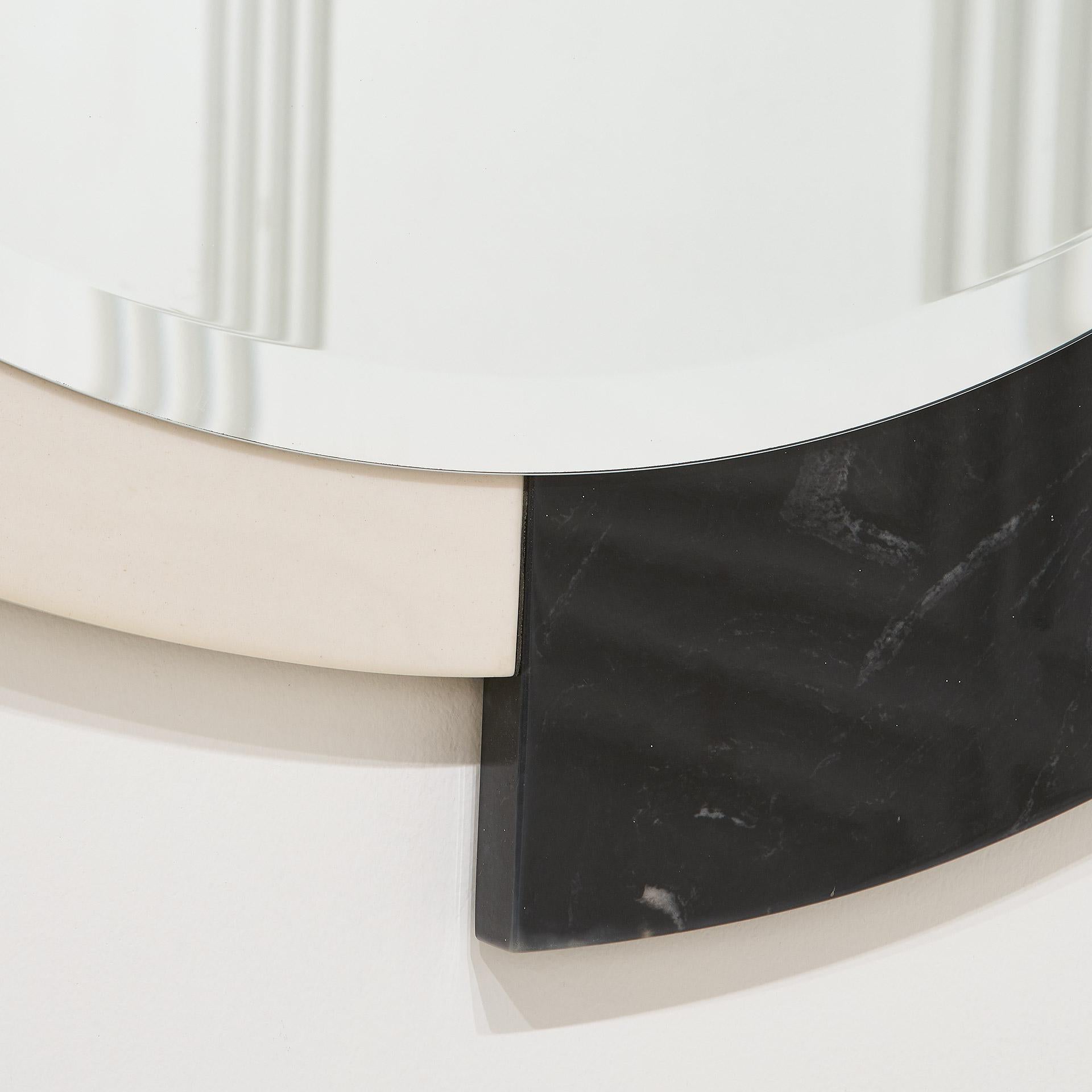 A Postmodern black and white mirror featuring a beveled mirror edge.

Overall dims: 36.25