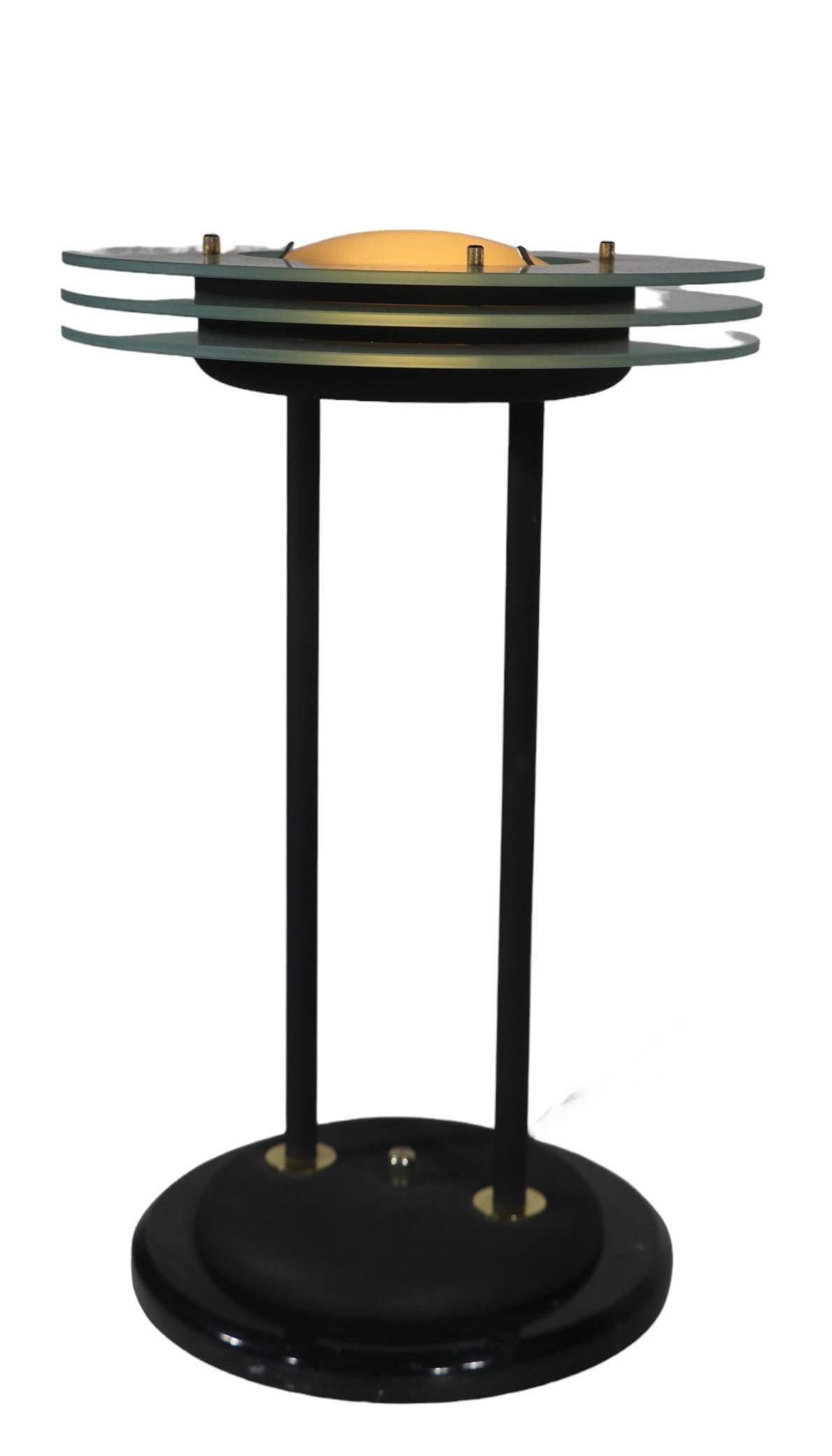 Rare Post Modern Saturn table lamp attributed to Sonneman, or possibly Kovacs, circa 1970/80's. The lamp features three frosted glass rings, with a frosted glass dome top  shade, supported by two metal columns, on a marble plinth base. The lamp has