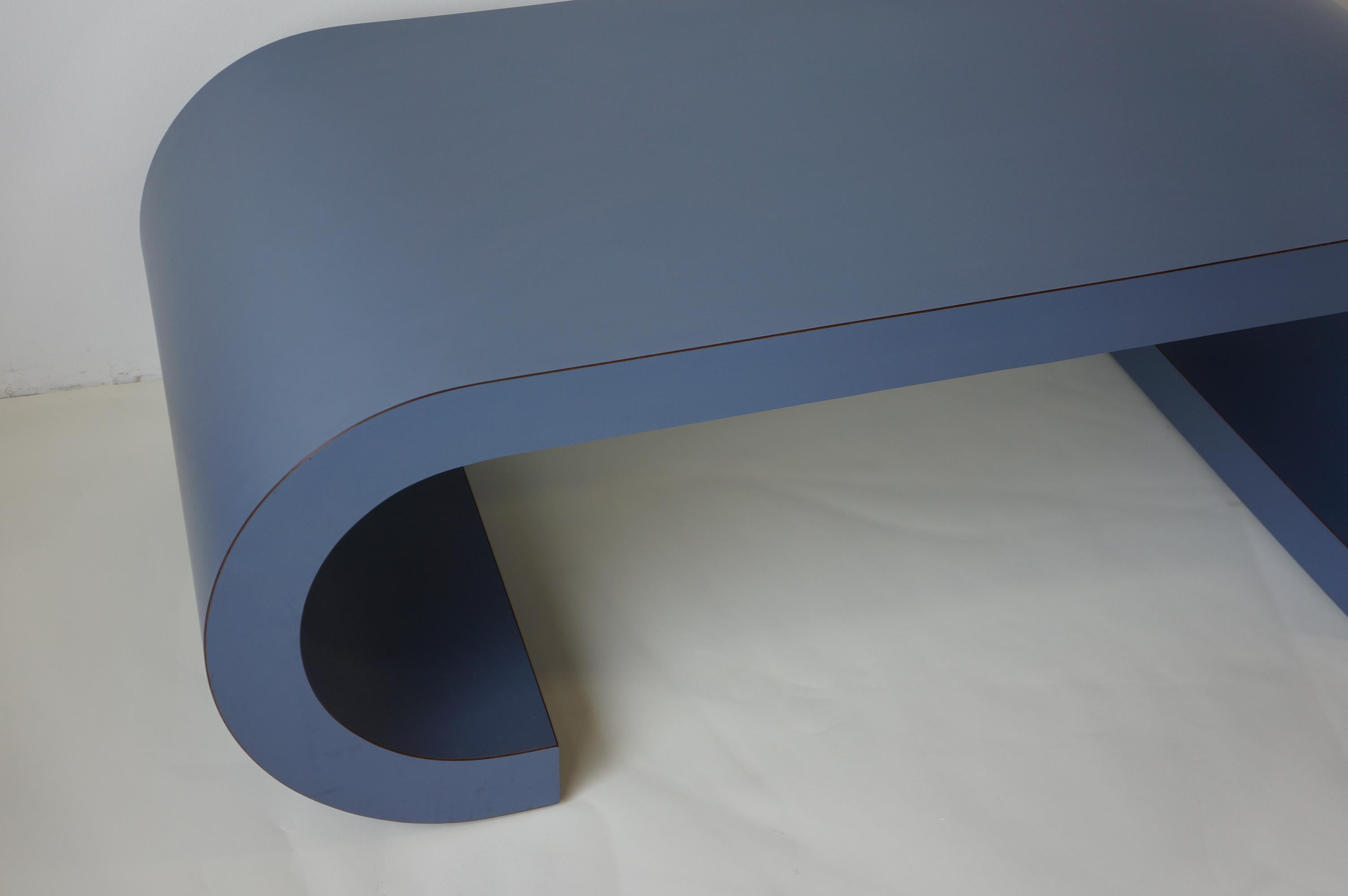 Amazing postmodern custom made coffee table scroll table in a gorgeous colour. This table is laminated in a beautiful blue colour. It was custom built in the late 1980s and this scroll design remains timeless both in its quality and its structure.