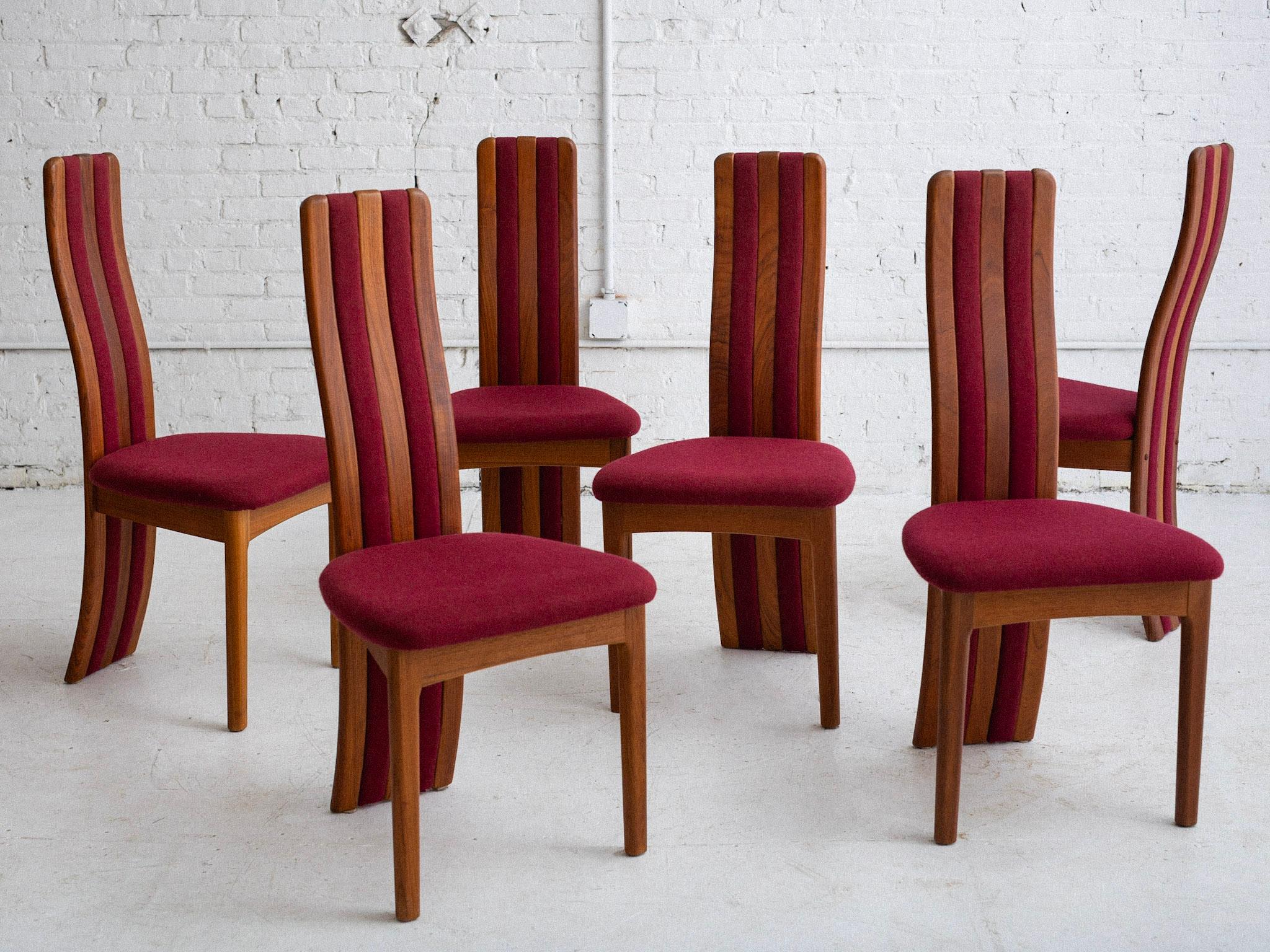 A set of 6 dining chairs by Benny Linden. Sculpted high back silhouette. Teak backs with upholstered channels create a stripe effect. Original burgundy wool fabric.