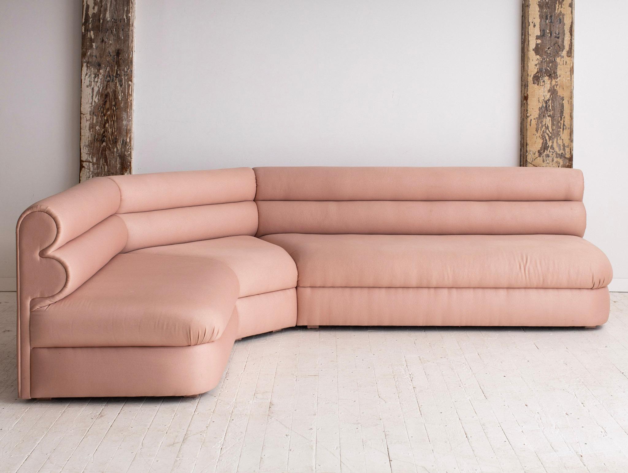 Three piece 80s Post Modern sectional. Original satin sheen blush fabric. Sculptural channeled back gives off a great graphic silhouette. Pieces interlock securely with wood clips. Sourced in South Florida. 
Individual measurements:
Longest piece: