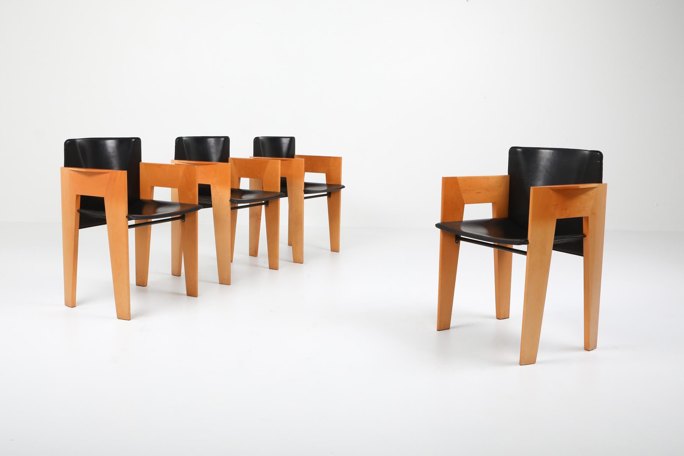 Postmodern chairs by Arco, The Netherlands, ebonized oak and saddle leather chairs, 1980s. 
Unusual armchair designed by a Dutch architect. Sculptural and elegant appearance mixed with quality materials make these a great design. We have 4 pieces